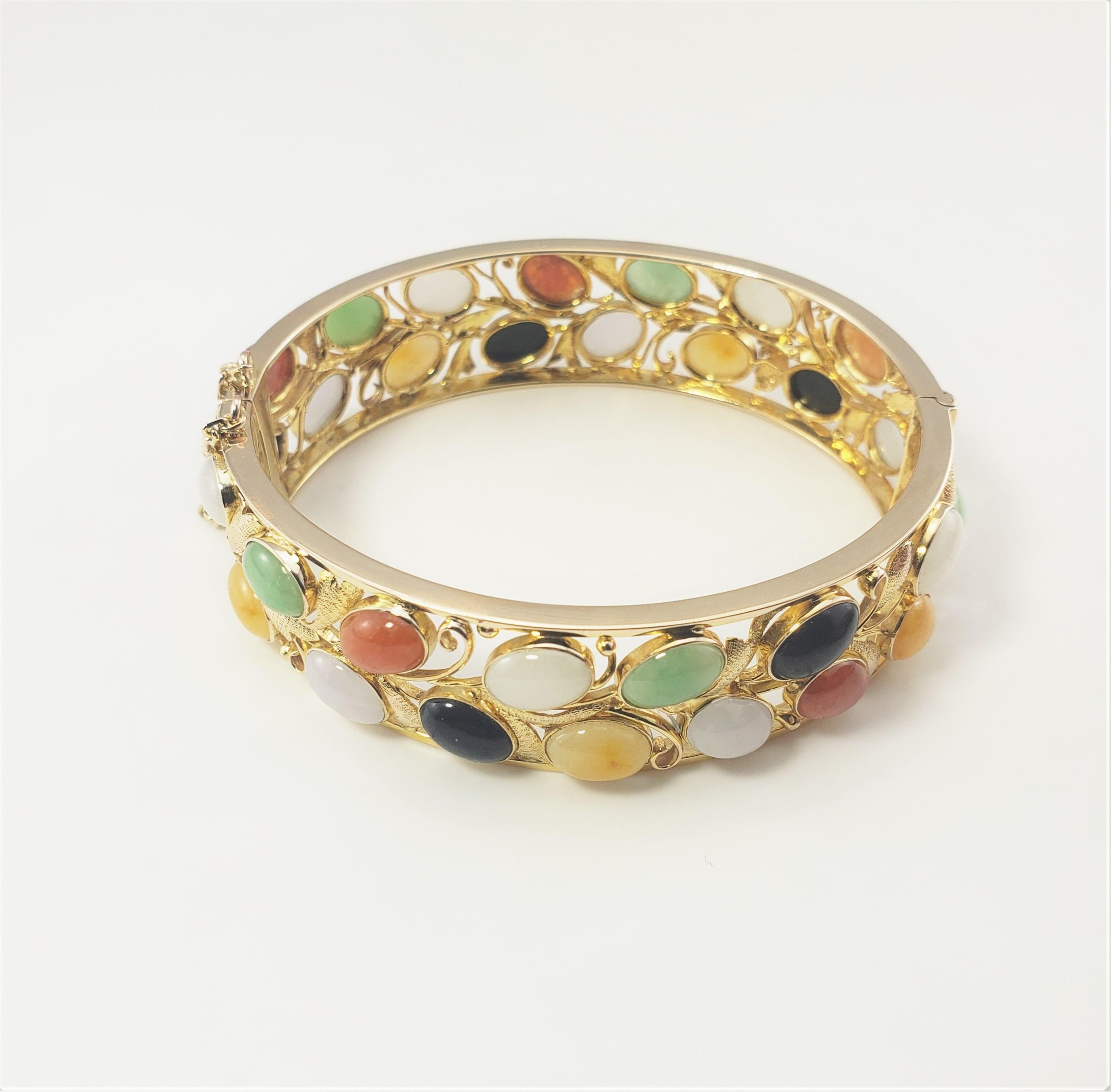 14 Karat Yellow Gold Gemstone Bangle Bracelet-

This lovely hinged bracelet features 30 oval gemstones (carnelian, onyx and jade) set in beautifully detailed 14K yellow gold.  
Width:  16 mm.  Safety chain closure.

Size: 6.5 inches 

Weight:  19.8