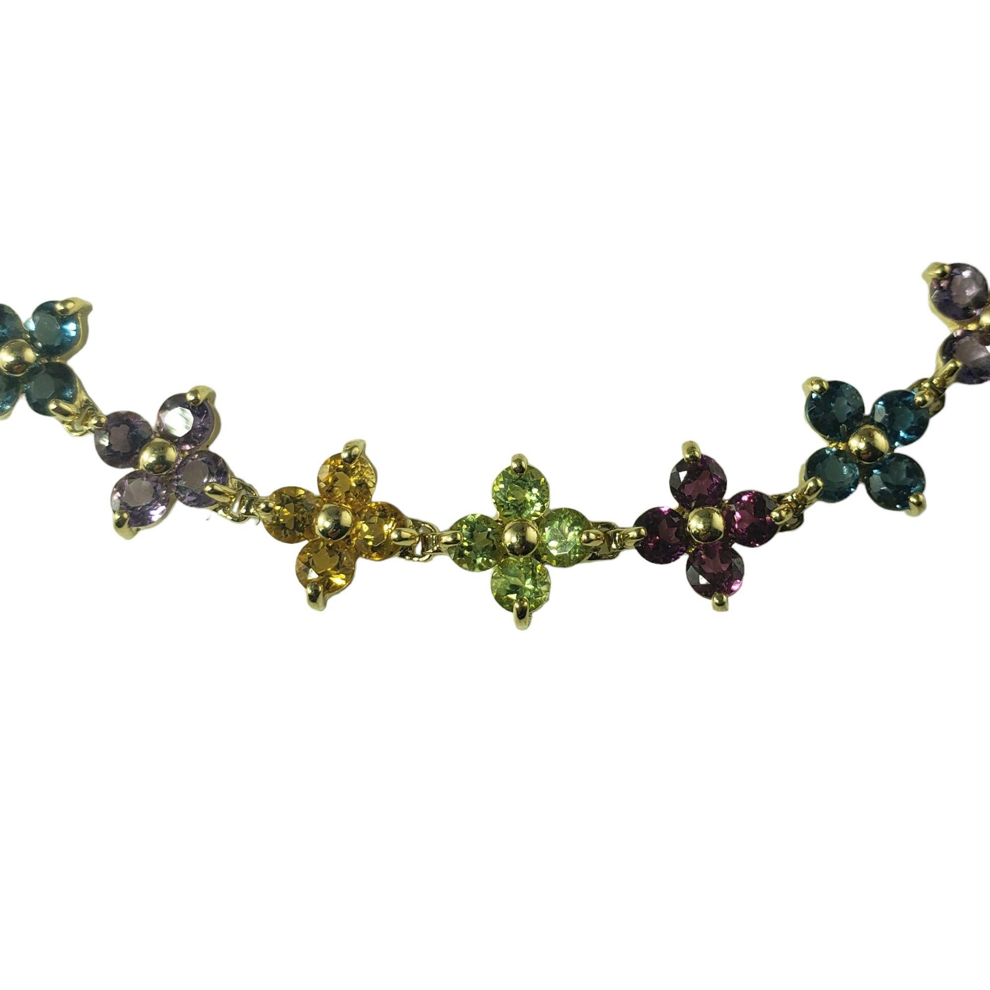 This elegant floral motif bracelet is decorated with 16 round garnets, 16 round blue topaz, 16 round amethysts, 12 round citrines and

12 round peridots set in 14K yellow gold.  Width:  9 mm.

Total garnet weight:  2.56 ct.

Total topaz weight: 