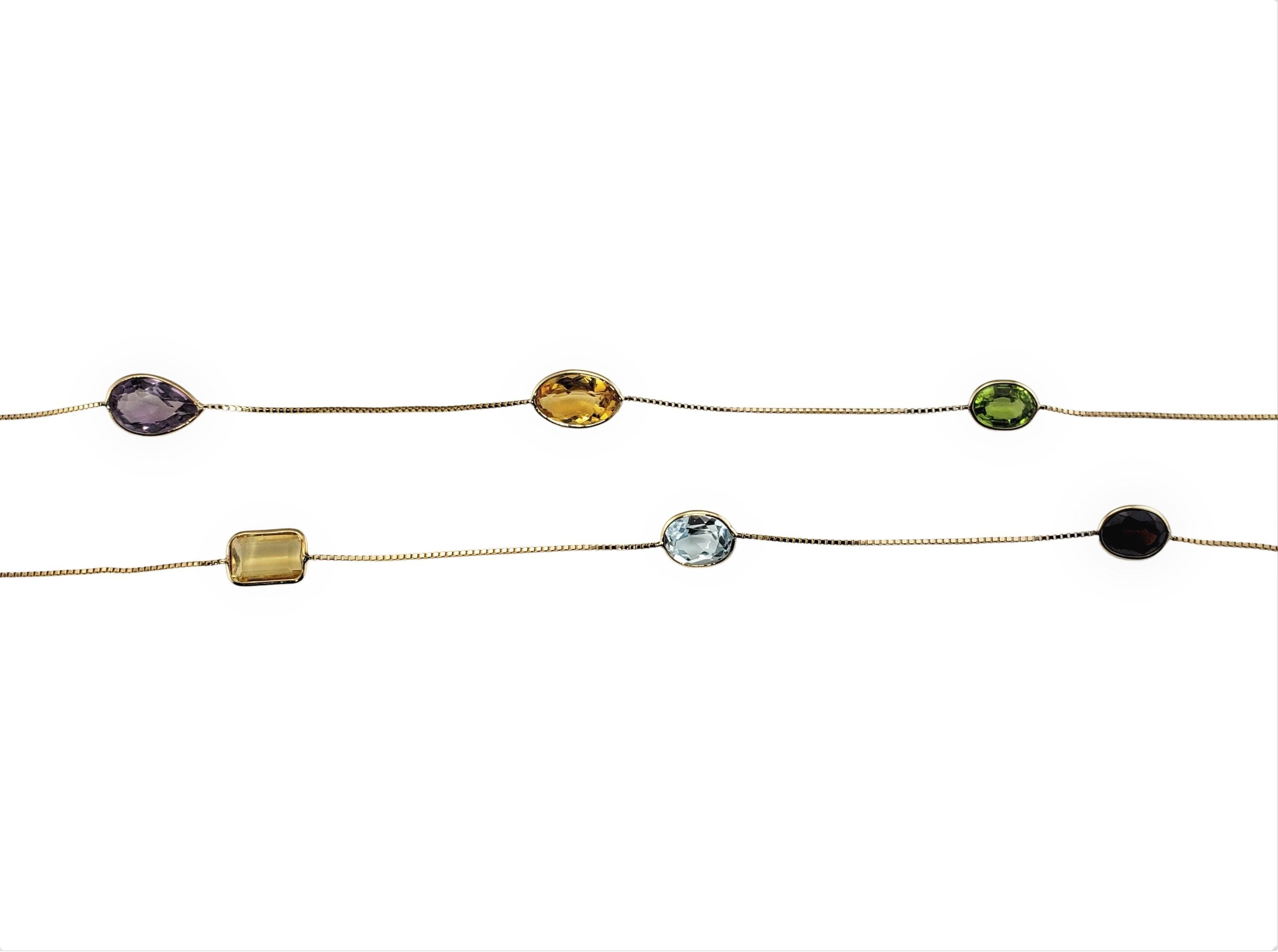 Vintage 14 Karat Yellow Gold Multi Gemstone Necklace-

This lovely necklace features assorted semi-precious stones set in a classic 14K yellow gold necklace.  

Center smoky quartz stone measures approx. 25 mm x 19 mm.  

Size: 36 inches - opera