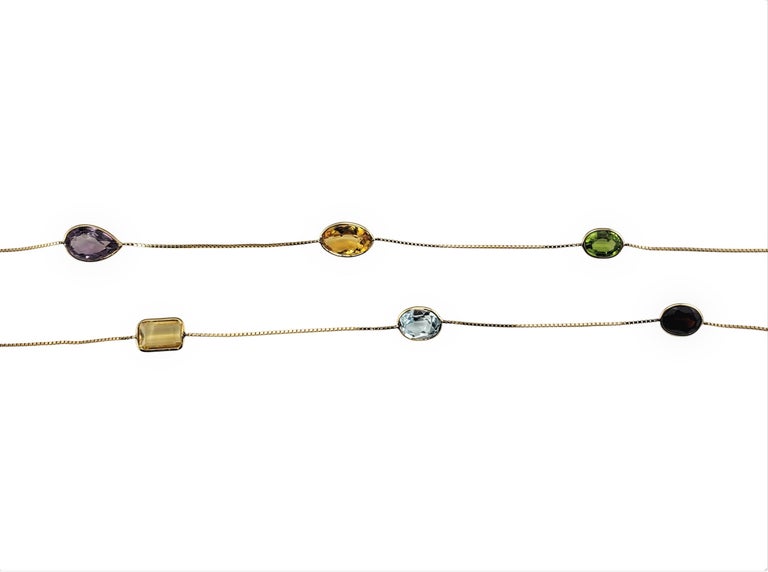 Vintage 14 Karat Yellow Gold Gemstone Necklace-

This lovely necklace features assorted semi-precious stones (amethyst, citrine, garnet, topaz) set in a classic 14K yellow gold necklace. Center stone measures 26 mm x 29 mm.

Size: 36 inches

Weight: