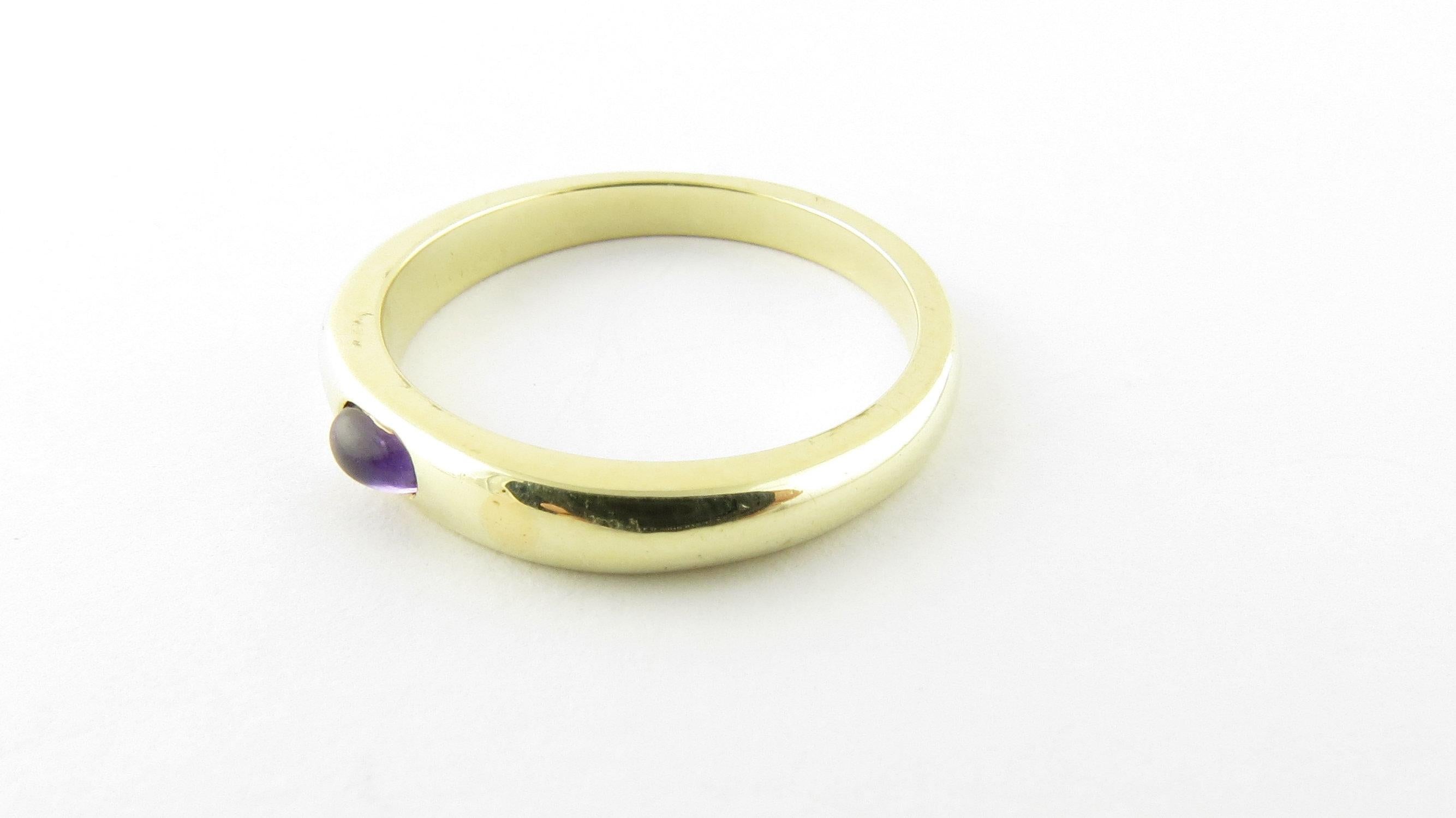 Vintage 14 Karat Yellow Gold Genuine Cabochon Amethyst Stackable Ring Size 9. This lovely ring features one genuine cabochon amethyst (5 mm x 3 mm) set in elegant polished 14K yellow gold. Ring width: 4 mm. Shank: 2 mm.

Available matching stackable