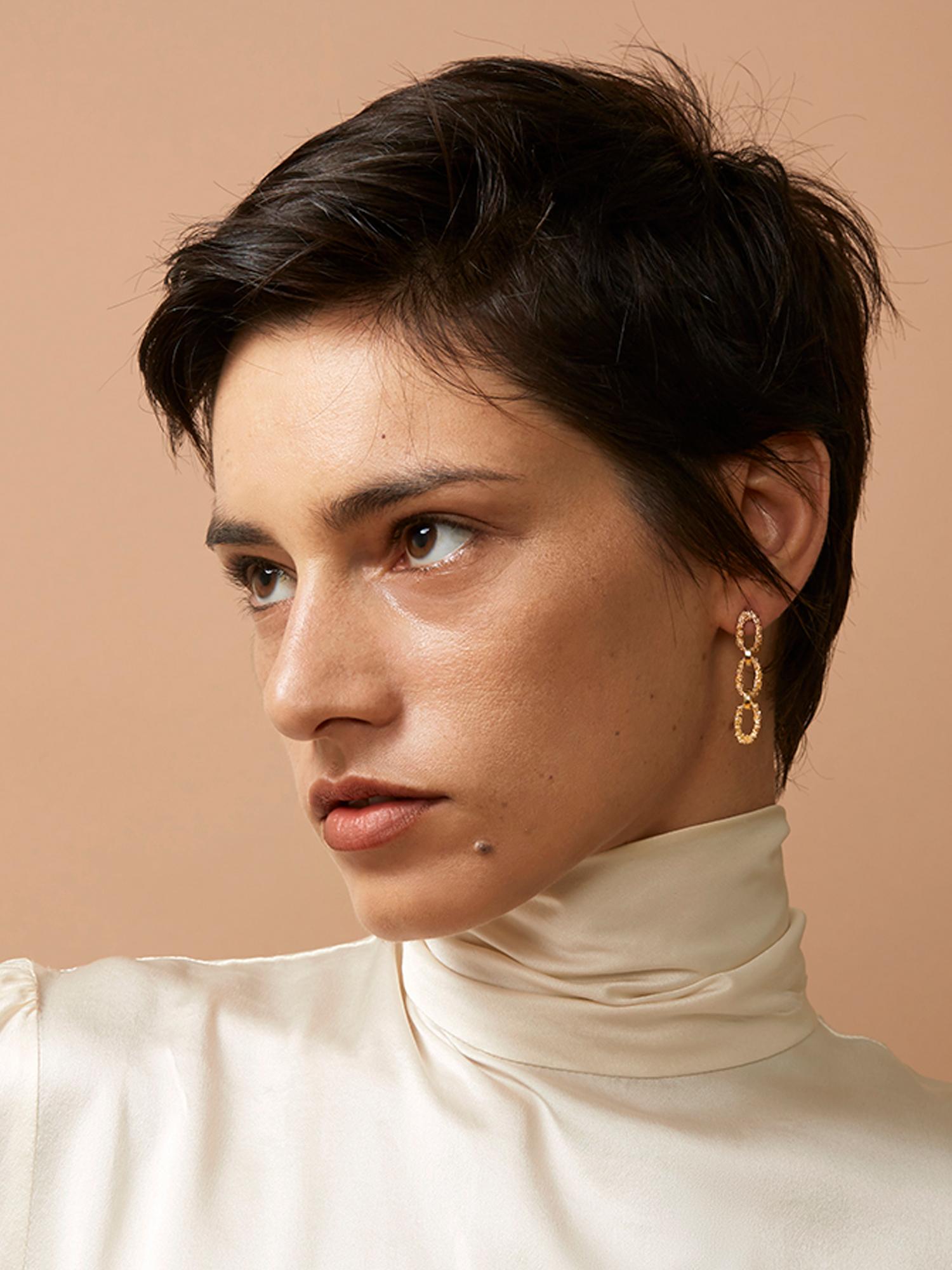 Designed with a modern edge, these unique earrings are crafted in the thousand year old technique of granulation where small spheres of gold are fused together to form and cover surfaces. Made from solid 14 karat recycled yellow gold, these post