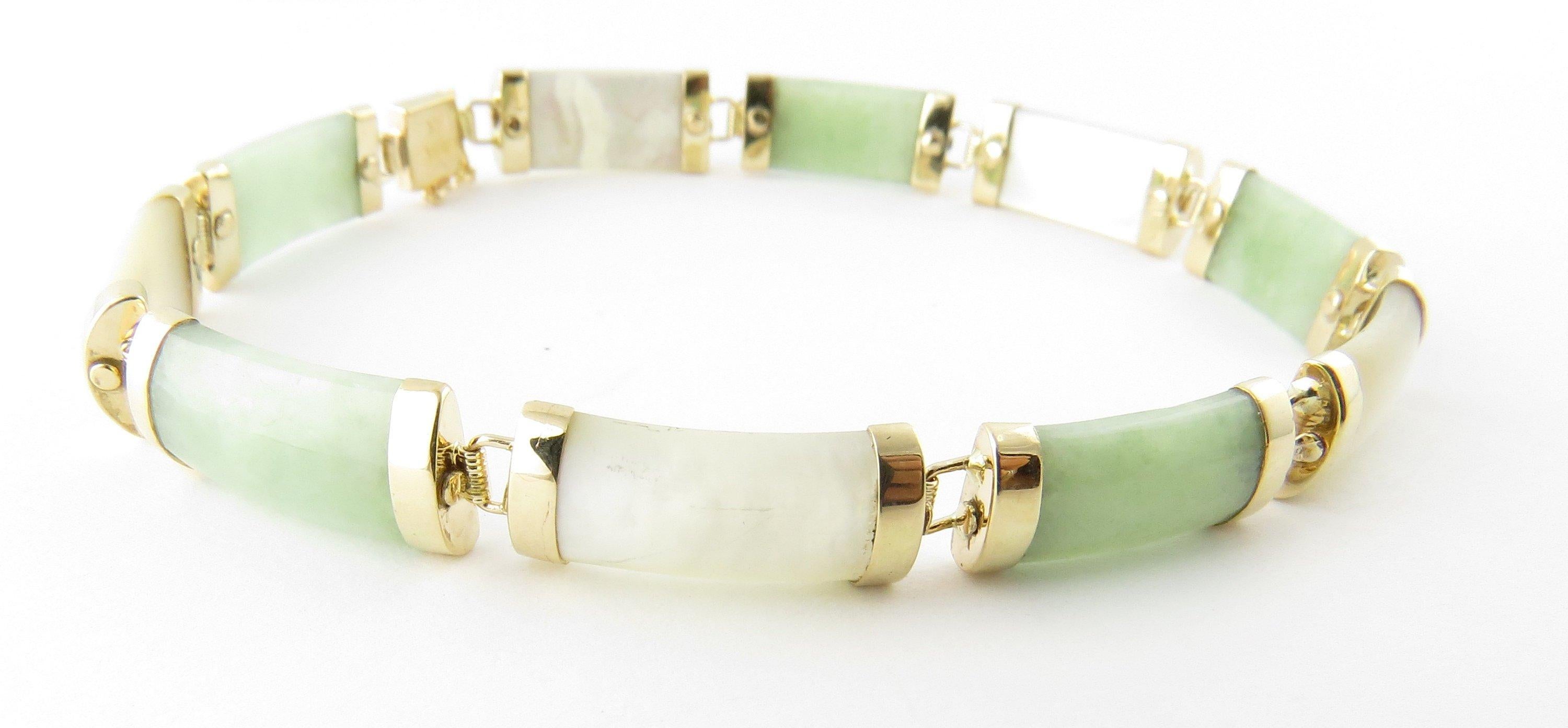 Vintage 14 Karat Yellow Gold Green and White Jade Bracelet- 
This lovely bracelet showcases five white jade links and five light green links each capped with polished 14K yellow gold. Clasp features Chinese characters for luck. 
Size: 7.5 inches