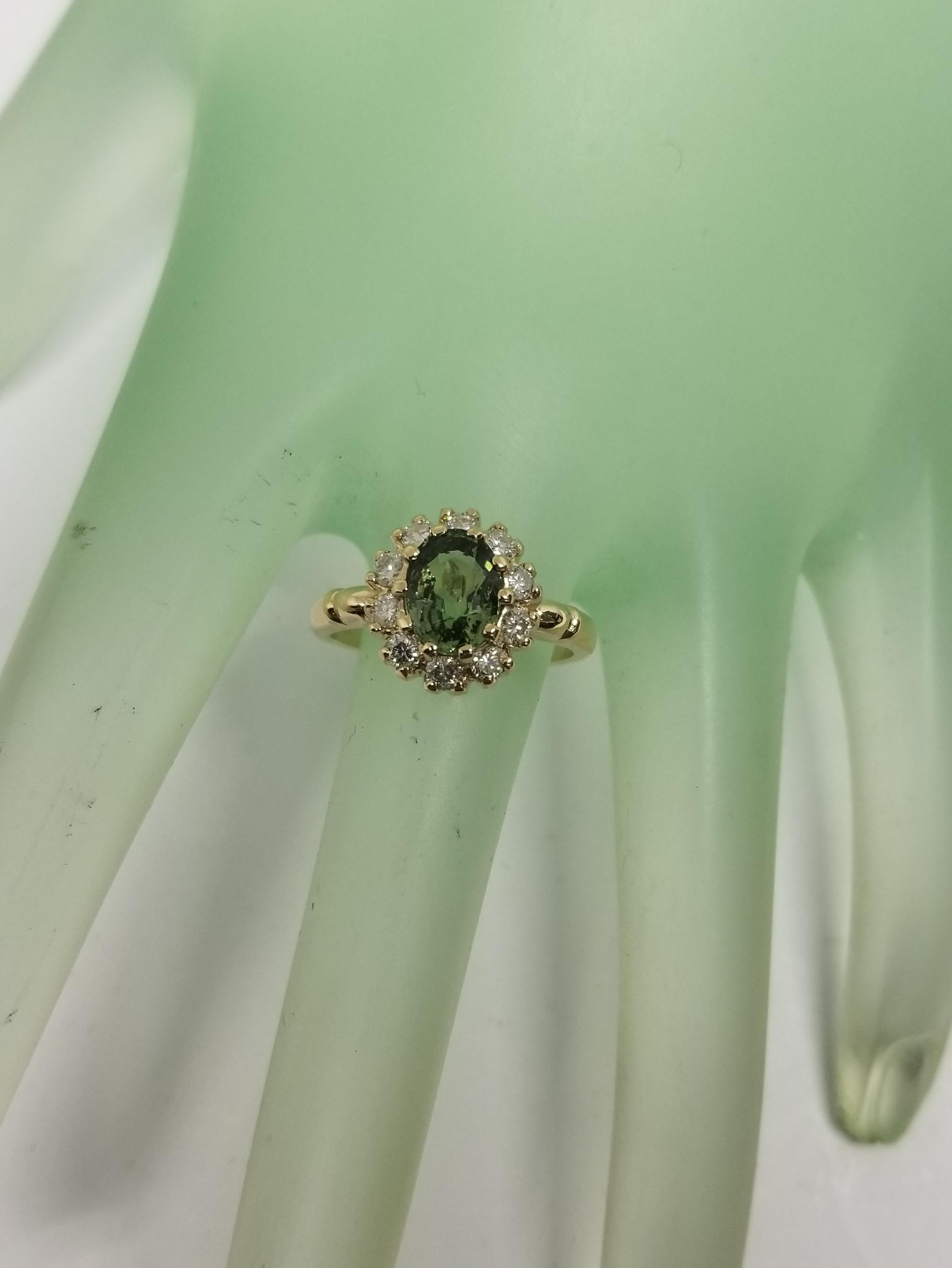 Contemporary 14 Karat Yellow Gold Green Sapphire Diamond Halo Ring For Sale