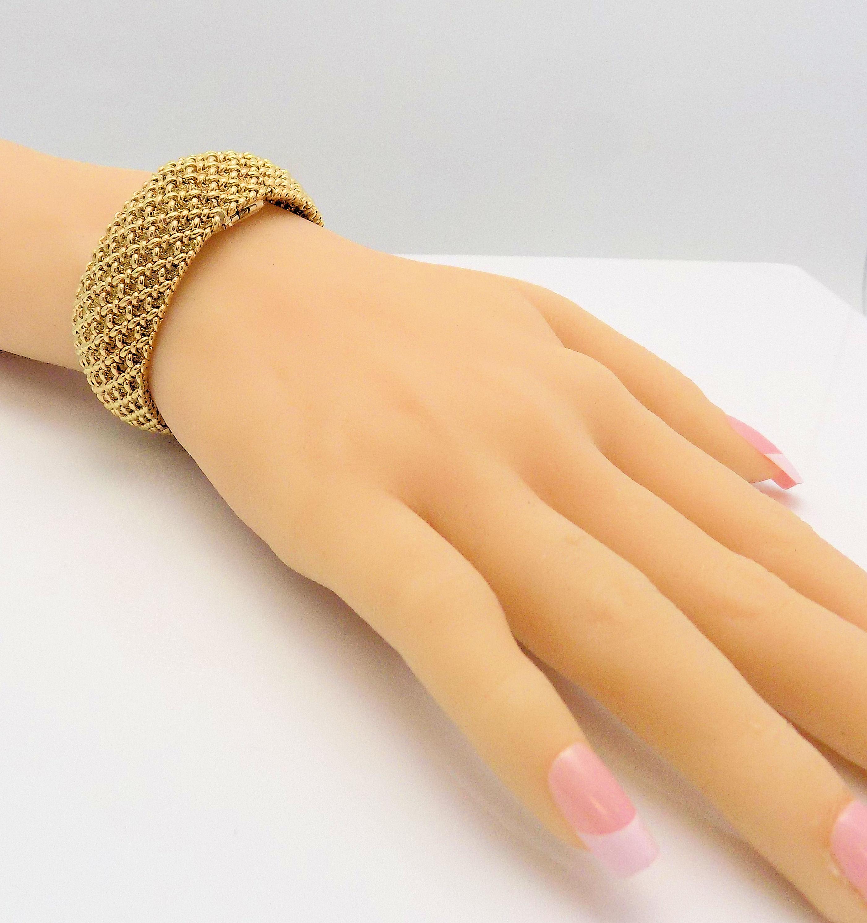 Glamorous is this 14 Karat Yellow Gold Hamilton Lady's Wristwatch with a Hidden Face and Woven Band that is 7/8