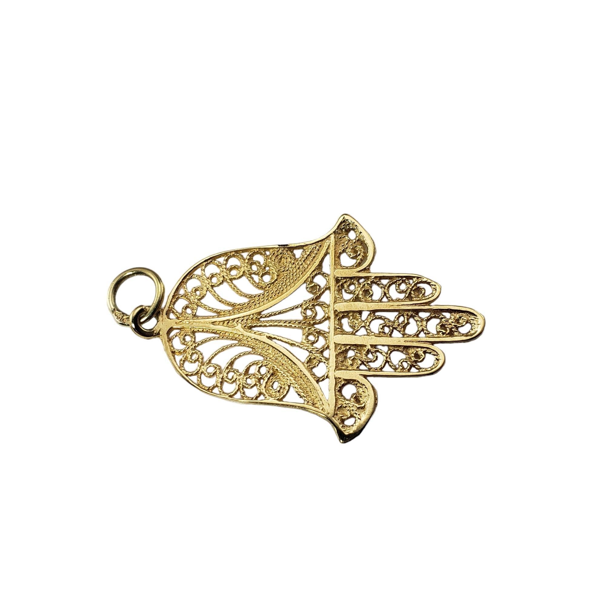 Vintage 14 Karat Yellow Gold Hamsa Pendant-

The Hamsa is believed to channel the forces of good, bringing happiness to all who wear it.  Crafted in beautifully detailed 14K yellow gold filigree.

Size: 36.3 mm x 25.4 mm

Stamped: 14K

Weight:  2.4
