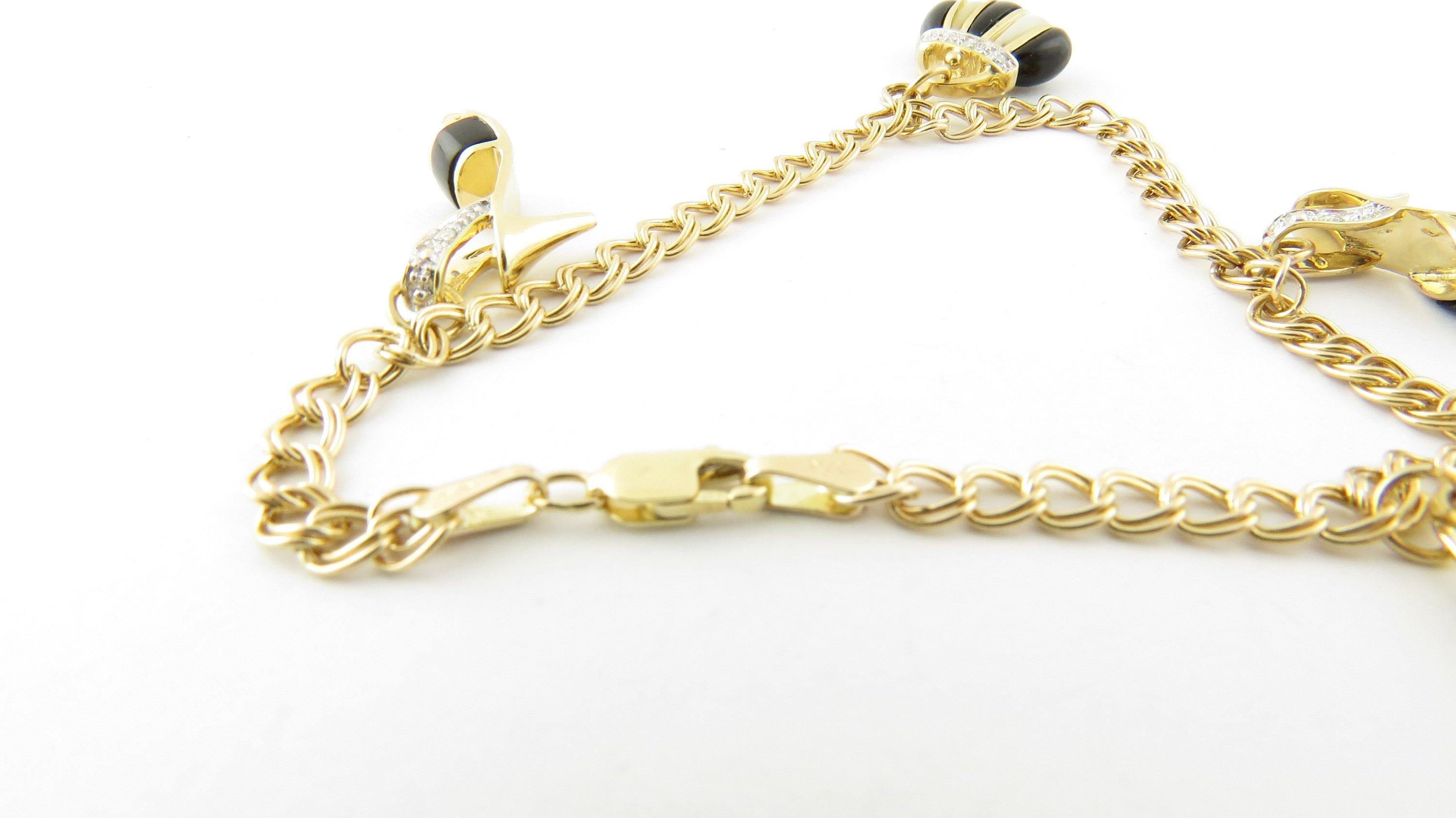 Vintage 14 Karat Yellow Gold Handbag and Shoe Charm Bracelet-Perfect gift for the fashionista! This lovely charm bracelet features two high heeled shoe charms and two handbag charms accented with black and white enamel. Each charm is decorated with