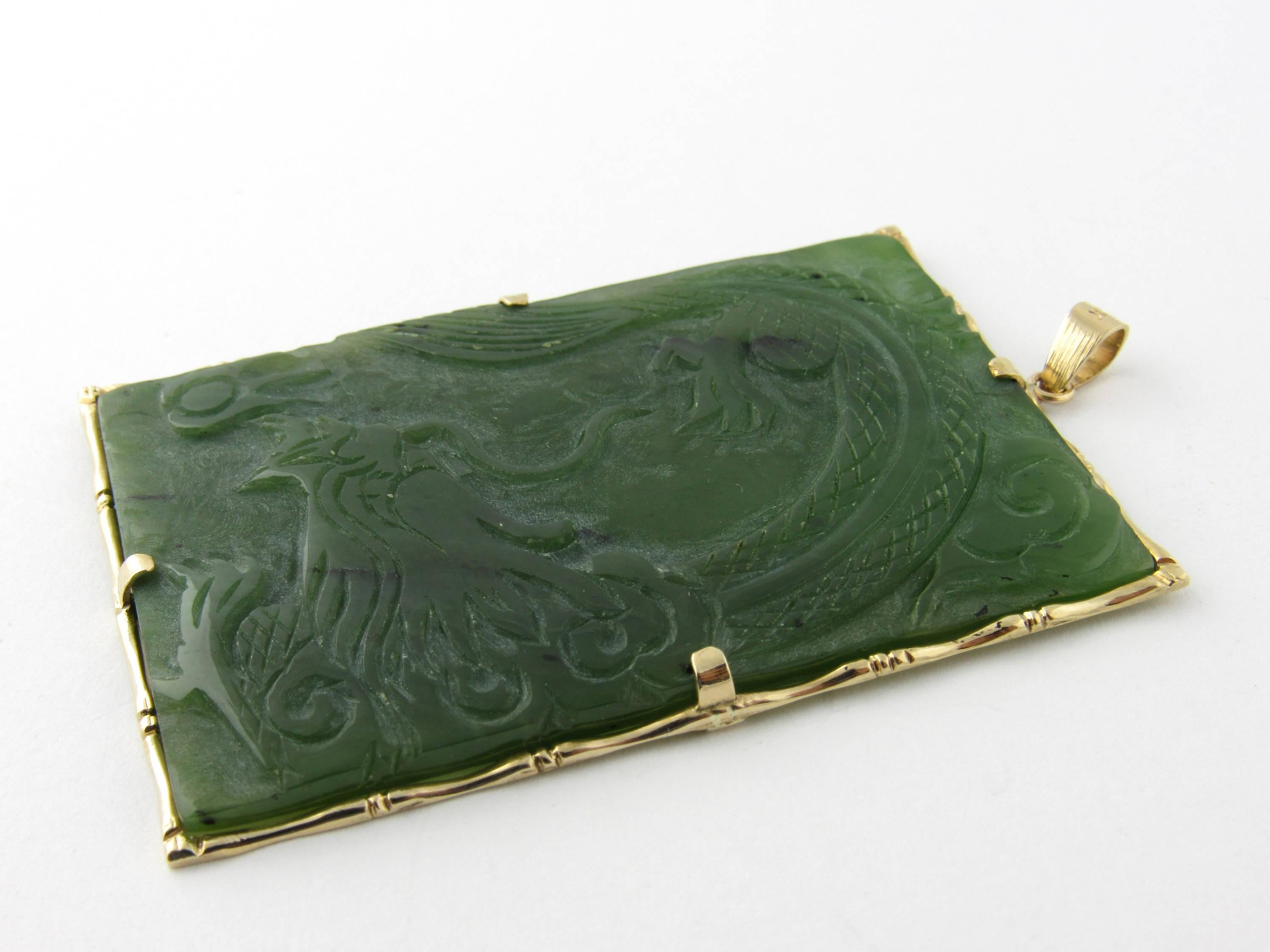 This statement piece features a genuine jade dragon pendant set in a 14K yellow gold bamboo frame. 
Size: 55 mm x 37 mm 
Weight: 11.1 dwt. / 17.4 gr. 
Hallmark: 14K 
Very good condition, professionally polished. 
Will come packaged in a gift box and