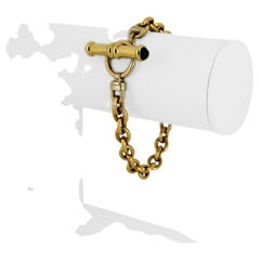 Bracelet en or jaune 14 carats pour femme, à maillons câblés ovales et à barrettes.