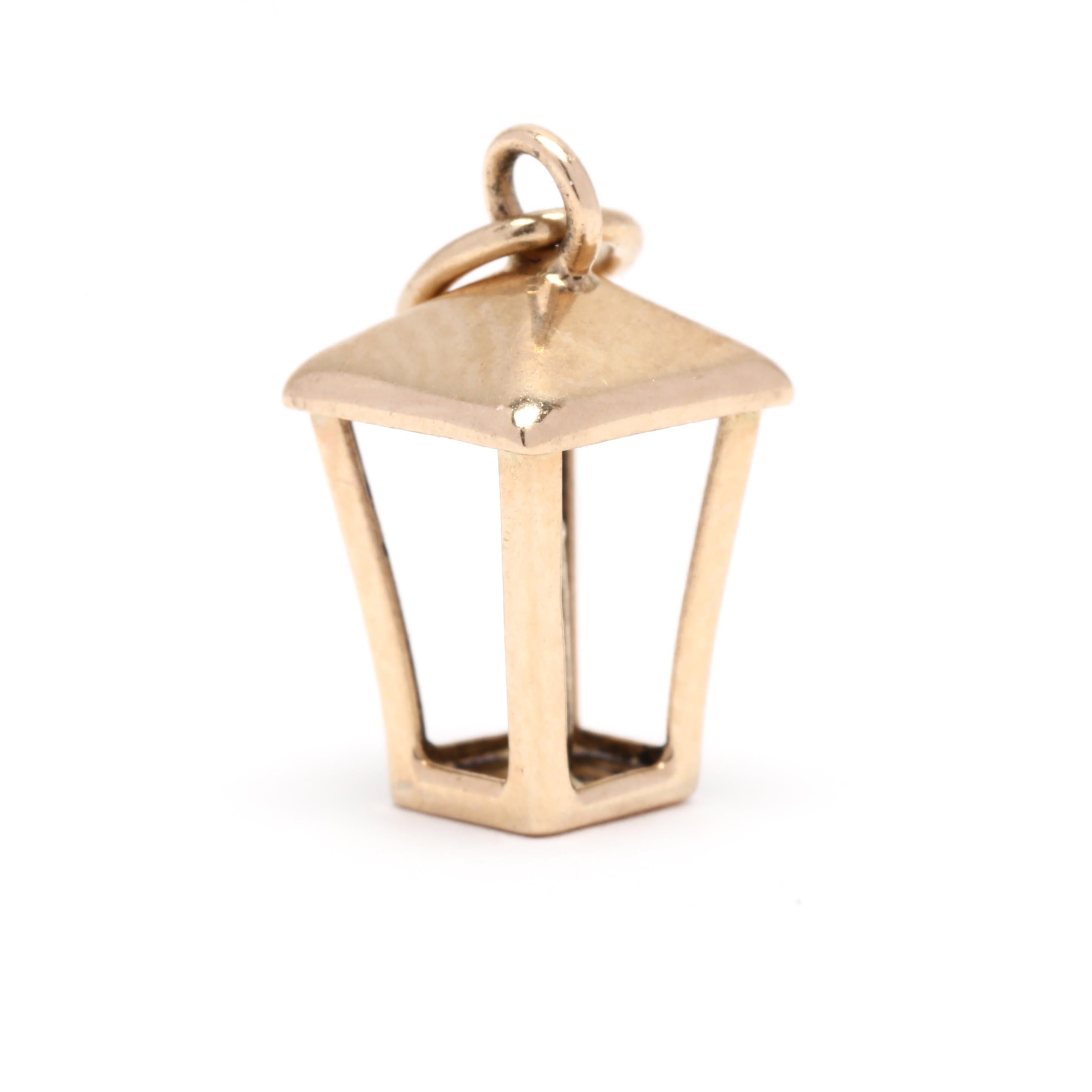 A vintage 14 karat yellow gold lantern charm. This charm features a three dimensional lantern motif with candle in the center and a thin bail.



Length: 5/8 in.



Width: 1/4 in.



Weight: .60 dwts.