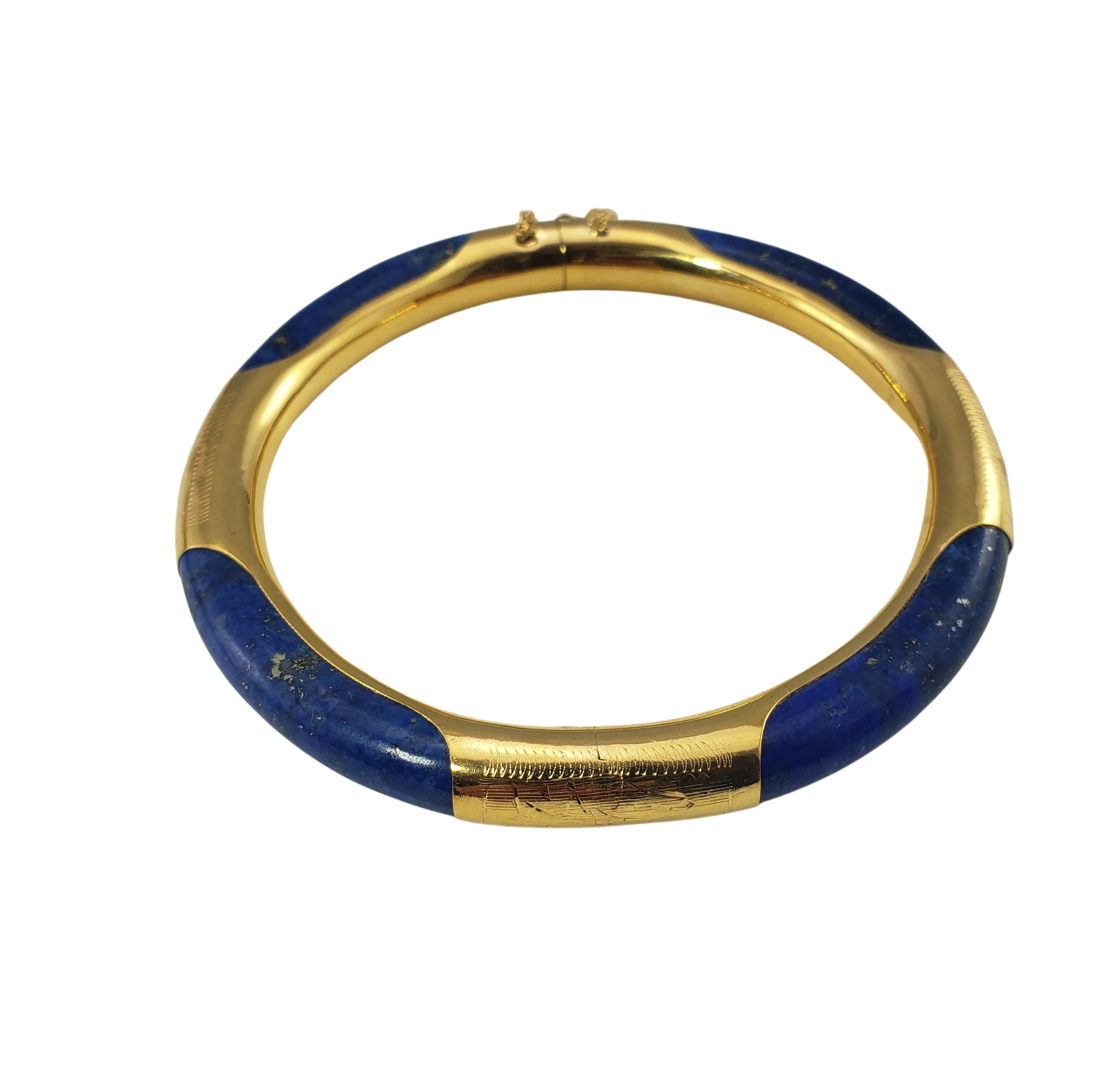 14 Karat Yellow Gold and Lapis Lazuli Bangle Bracelet-

This lovely hinged bangle bracelet is crafted in beautifully detailed 14K yellow gold and lapis lazuli.  Width:  7 mm.  Safety chain closure.

Size:   7.25 inches

Weight:   14.6 dwt. /  22.8