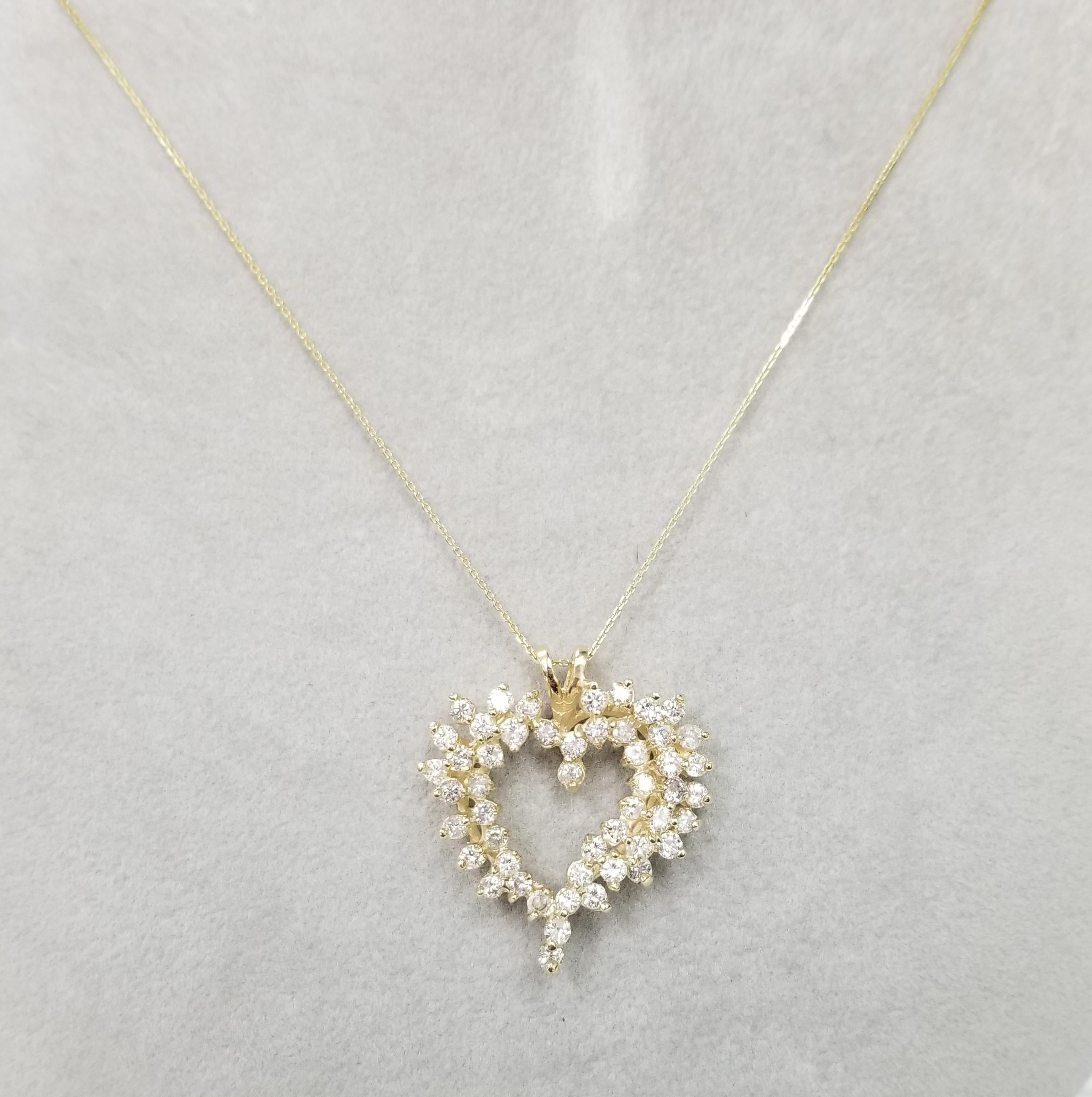 14k yellow gold large diamond heart pendant containing  50 round full cut diamonds weighing 2.56cts. color G, clarity SI on a 18 inch chain.