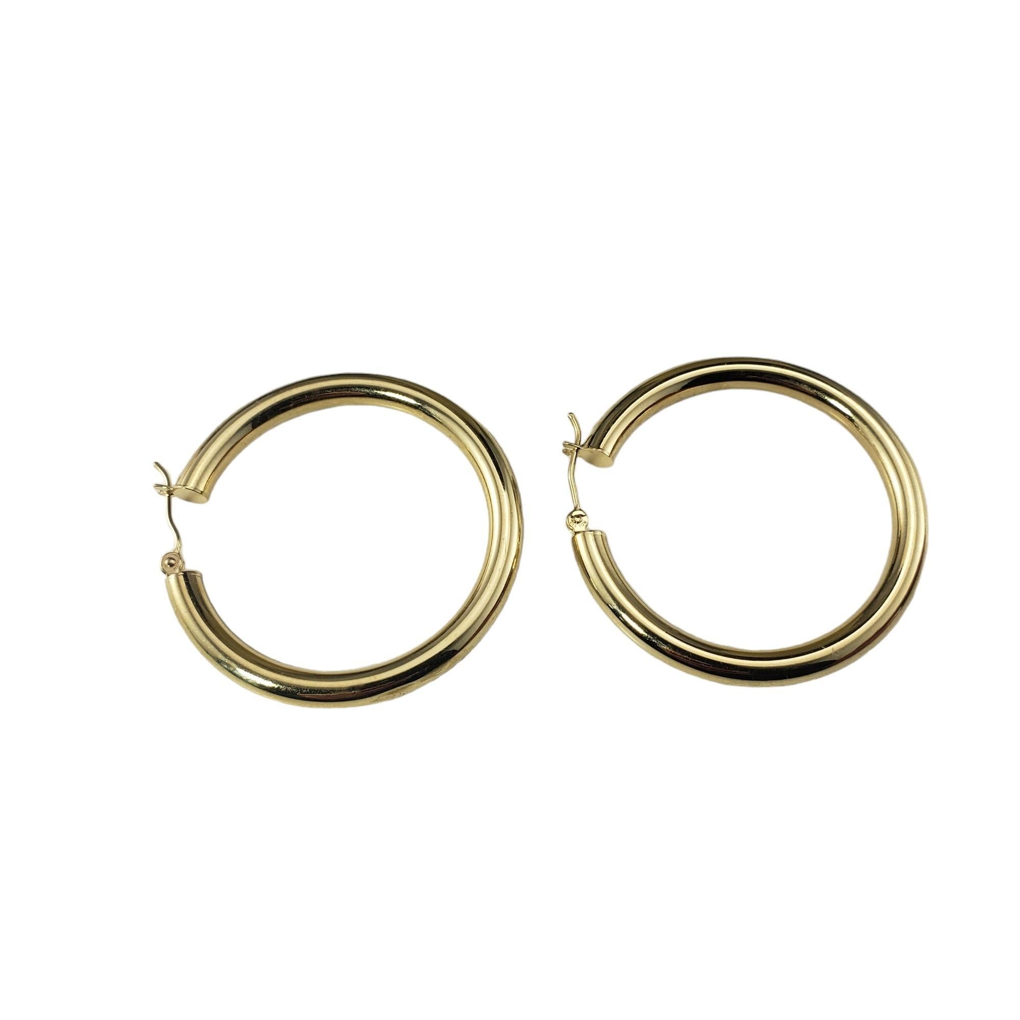 14 Karat Yellow Gold Large Hoop Earrings-

These elegant hoop earrings are crafted in meticulously detailed 14K yellow gold.  

Width: 4 mm.

Size: 40 mm

Stamped: Indonesia RCI  14K

Weight: 3.1 dwt./ 4.8 gr.

Very good condition, professionally