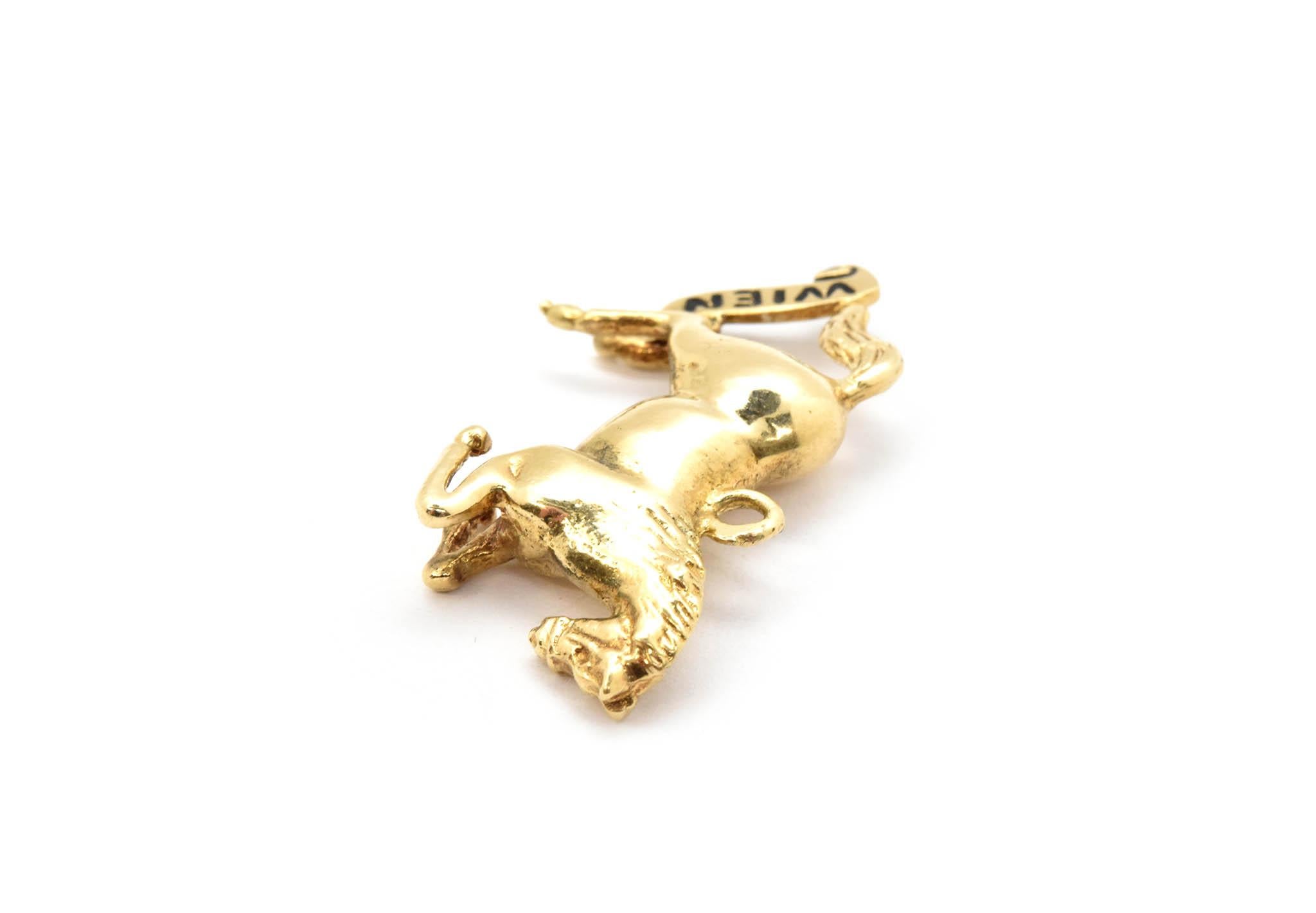 This pendant is made in 14k yellow gold in the shape of a rearing horse. 
There is a decorative banner at the back legs that reads “WEIN”. This means “Vienna” in English. The charm measures 30x15mm, and it weighs 5.38 grams. 
