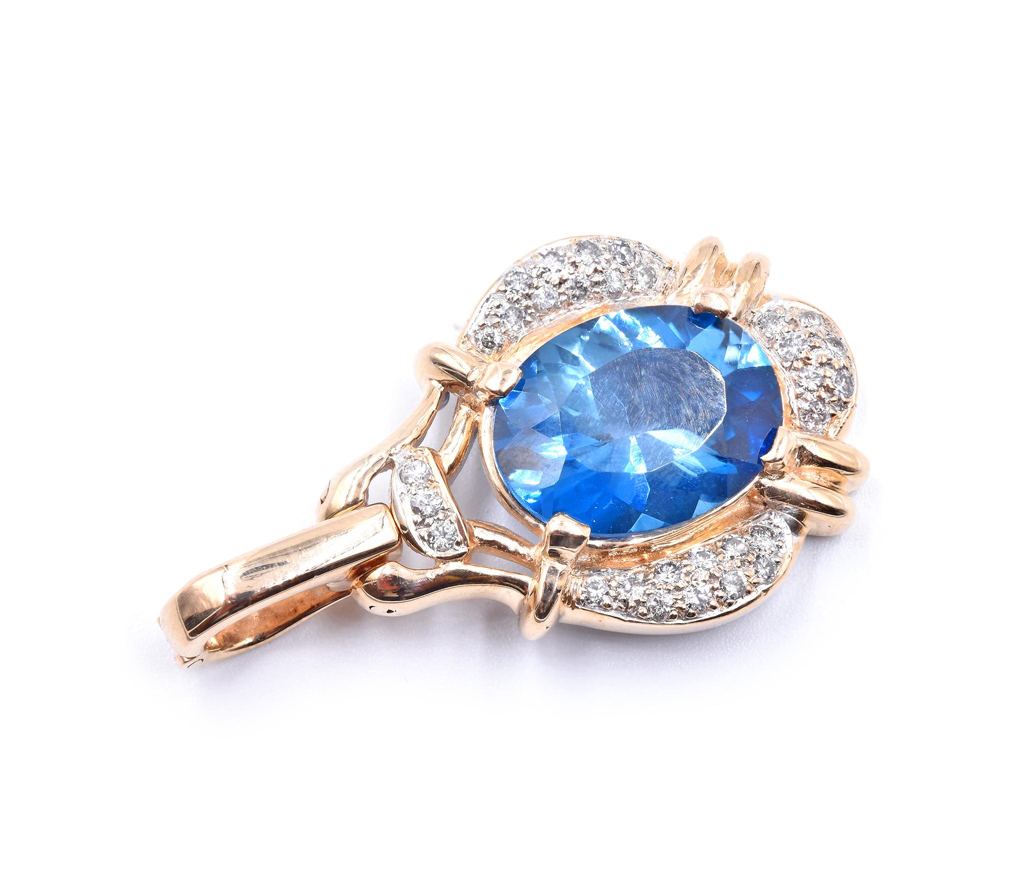 Designer: custom
Material: 14K yellow gold
Blue Topaz: 1 oval = 10.57ct
Color: London Blue
Diamond: 29 round cut = .60cttw
Color: G
Clarity: SI1
Dimensions: pendant measures 40 X 23mm
Weight: 10.11 grams