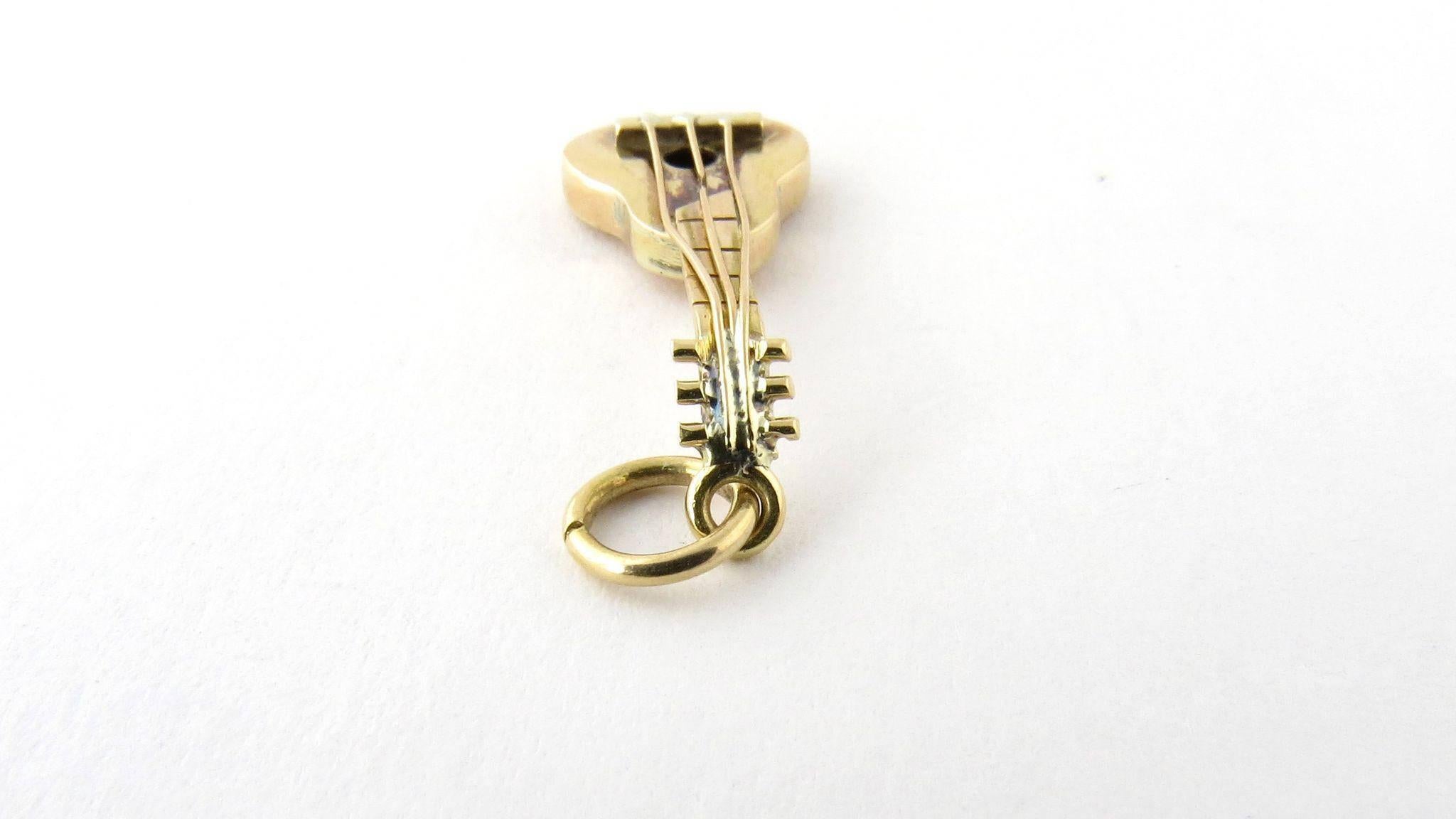 Vintage 14K Yellow Gold Lute Guitar Charm Pendant. 

This lute charm looks ready to be played with its beautiful gold strings. 

Acid tested and stamped 14K. 

2.0g / 1.3 dwt 

Hangs 31 mm from top of loop 10 mm wide 

This charm will be shipped