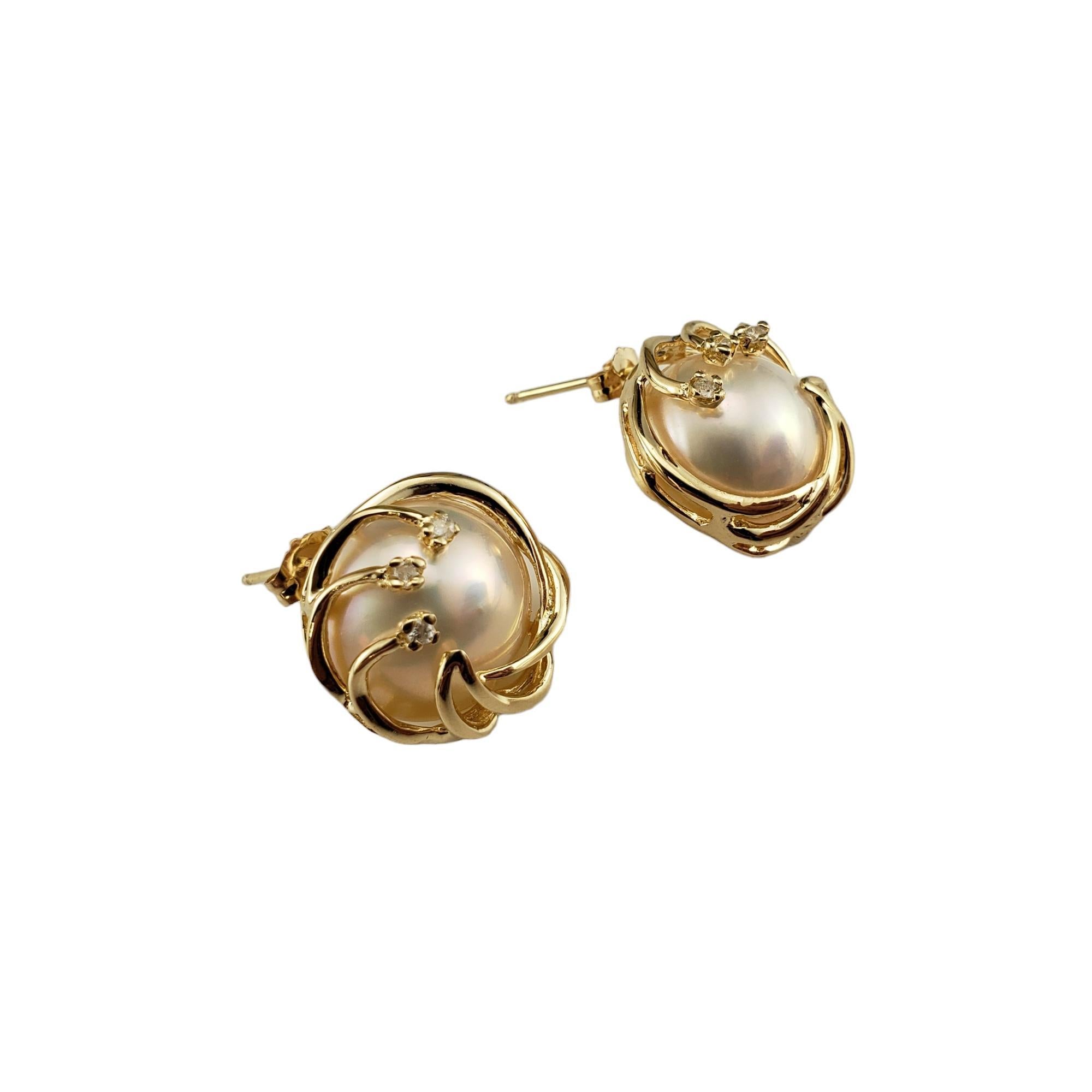 14 Karat Yellow Gold Mabe Pearl and Diamond Earrings-

These elegant earrings each feature one Mabe pearl and three round single cut diamonds set in classic 14K yellow gold.  Push back closures.

Matching ring: #16725
Matching pendant:
