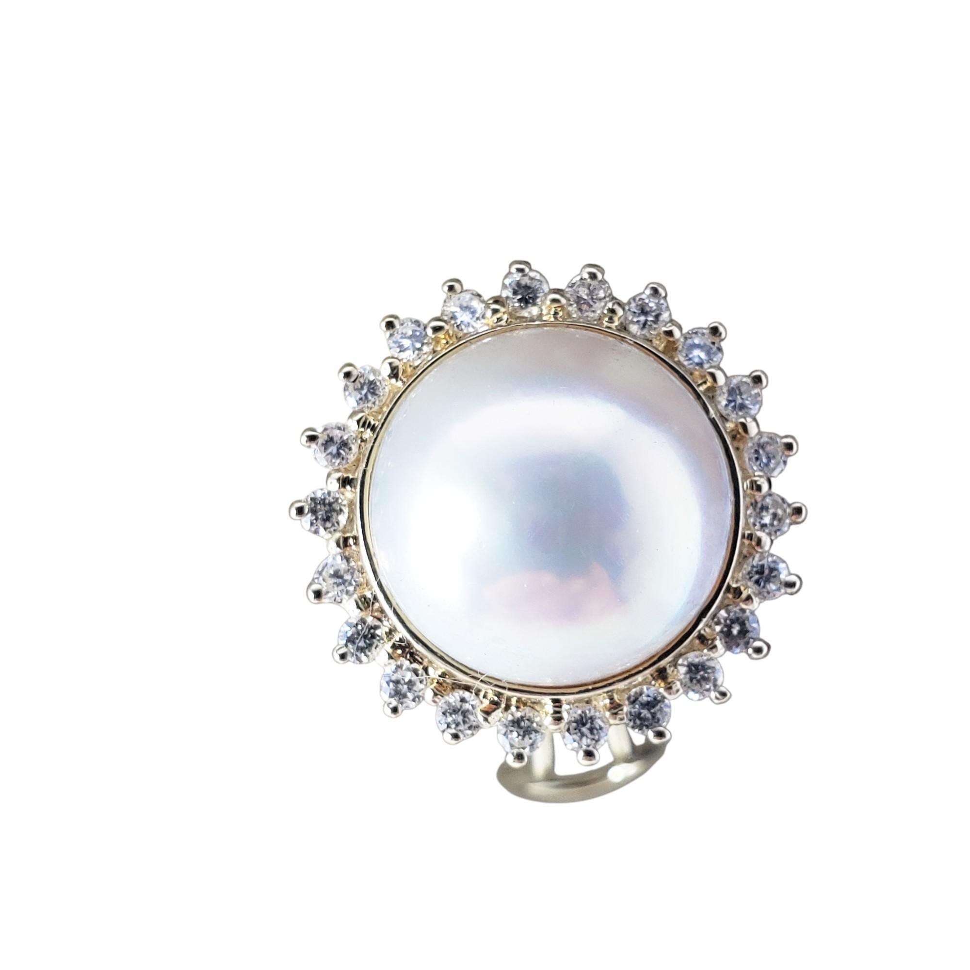 These lovely earrings each feature one round white mobe pearl (13 mm) surrounded by 22 round brilliant cut diamonds. Hinged closures.

Approximate total diamond weight: .88 ct.

Diamond color: G

Diamond clarity: SI1-VS2

Size: 19 mm

Weight: 6.3