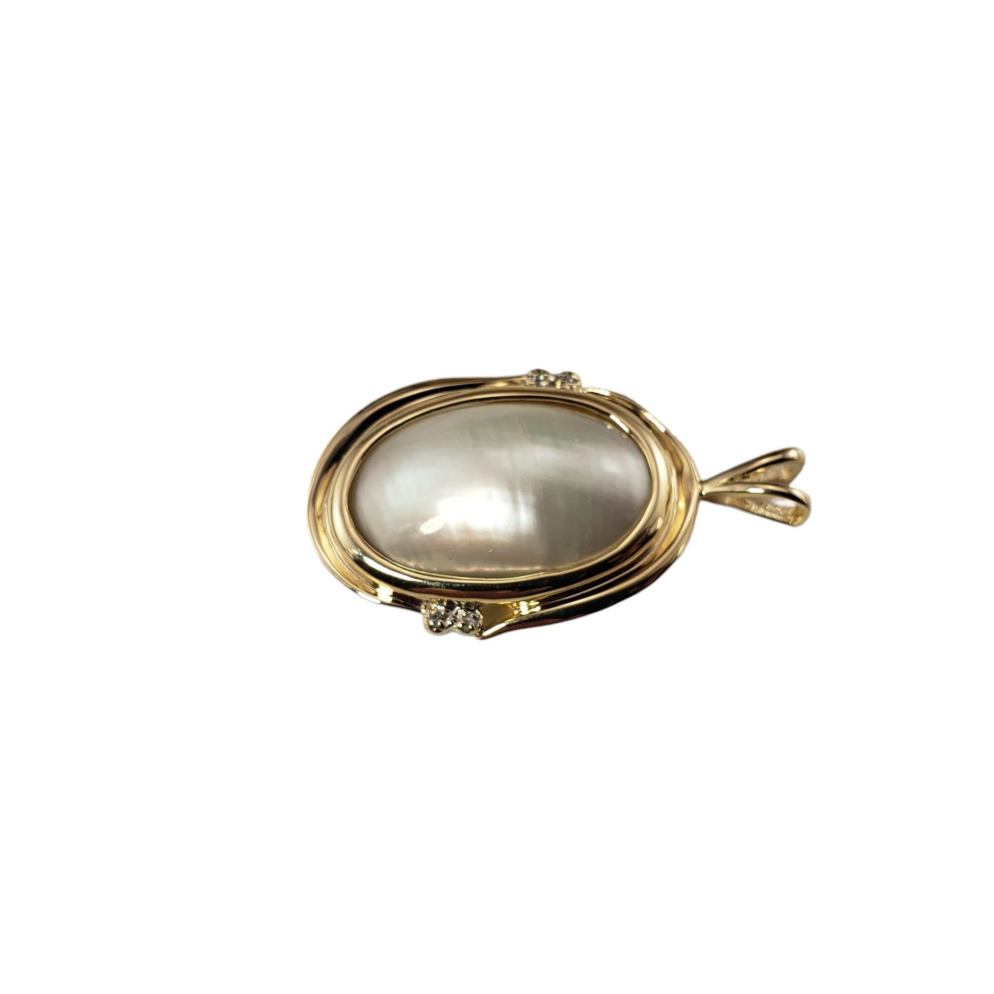 14 Karat Yellow Gold Mabe Pearl and Diamond Pendant-

This elegant pendant features one Mabe pearl (22 mm x 14 mm) and four round single cut diamonds set in classic 14K yellow gold.  

Approximate total diamond weight: .02 ct.

Diamond clarity: