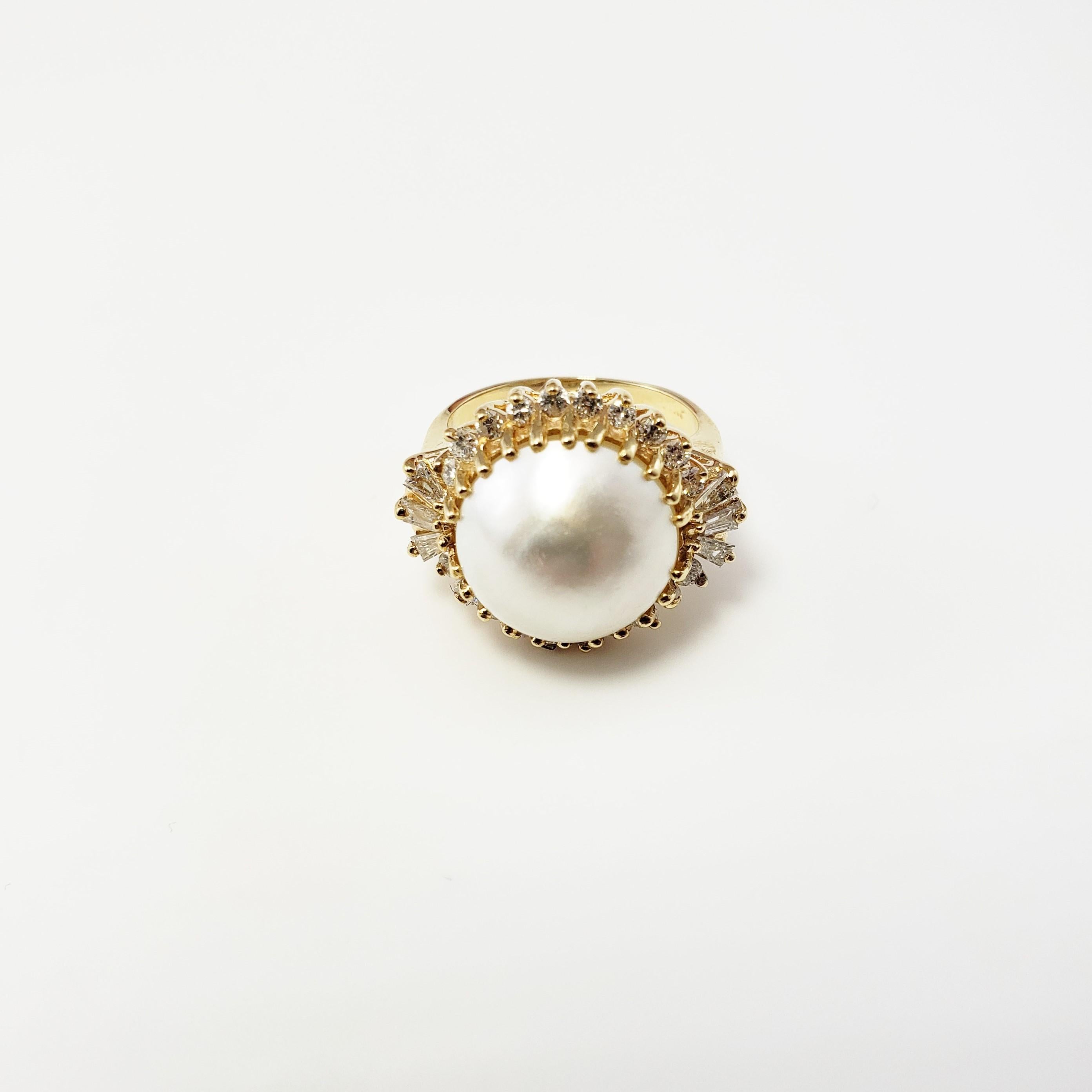 Vintage 14 Karat Yellow Gold Mobe Pearl and Diamond Ring Size 4.5-

This stunning ring features one Mobe pearl (11 mm) surrounded by six baguette diamonds and 20 round brilliant cut diamonds set in beautifully detailed 14K yellow gold. Top of ring