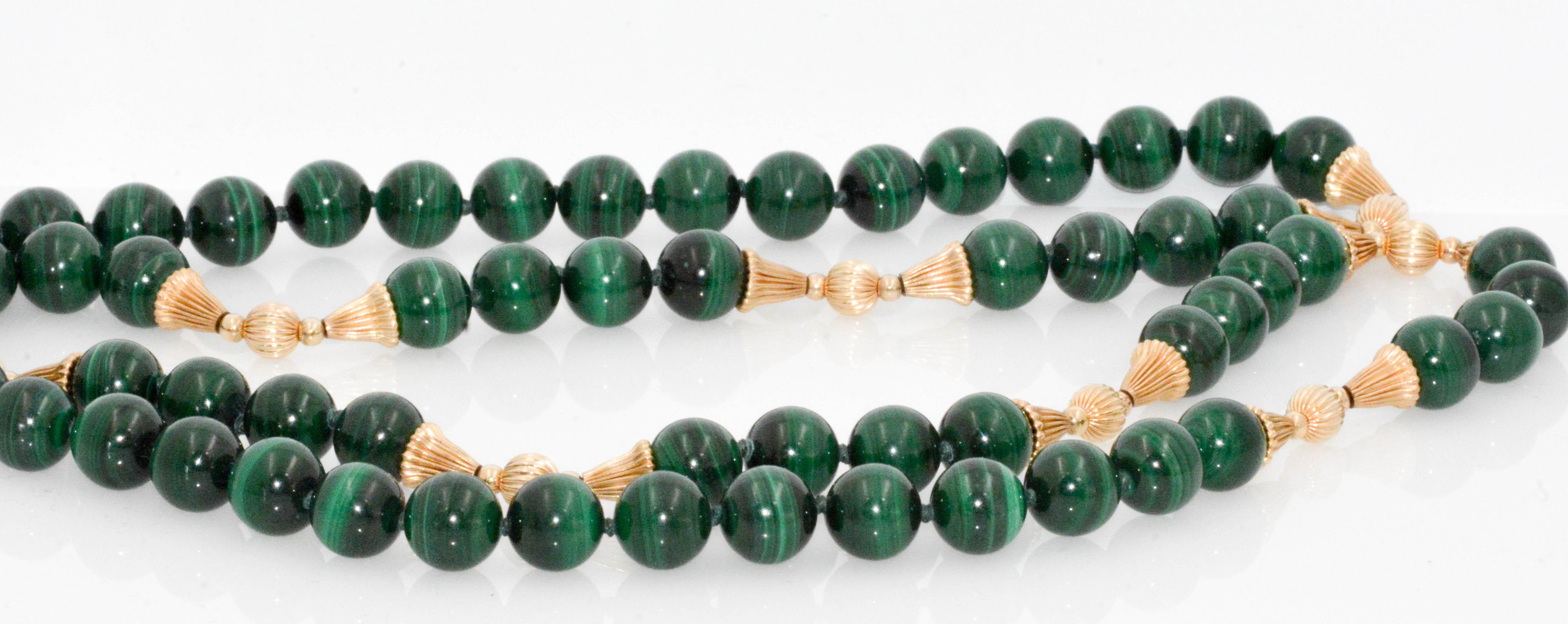 Whatever shape your day takes, breeze through the hours with this awe-inspiring intense, high quality green malachite bead necklace with eight (8) stunning 14 karat yellow gold stations. This graceful necklace features 62 malachite beads. Each bead