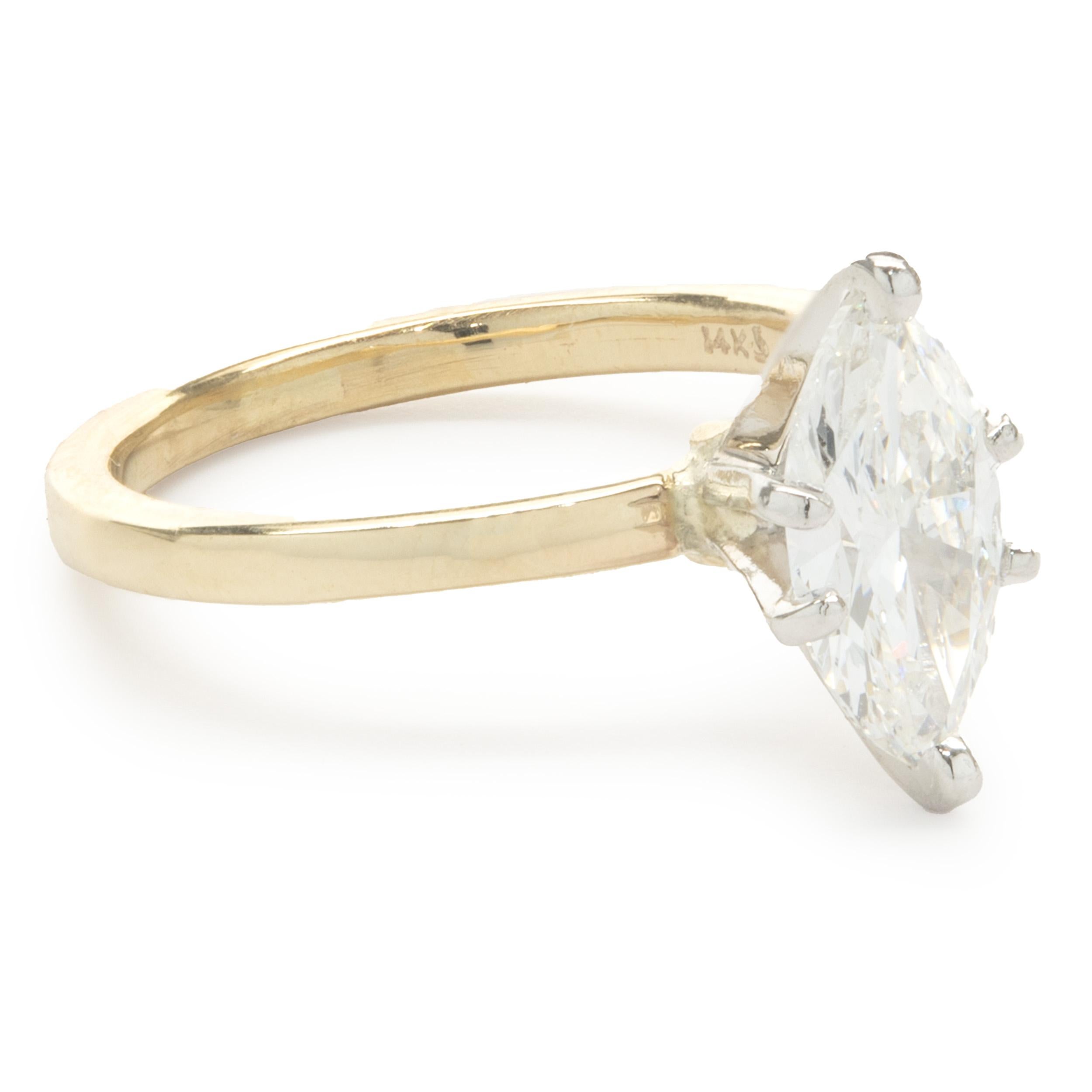 Designer: custom
Material: 14K yellow gold
Diamond: marquise cut = 1.00ct
Color: H
Clarity: SI2
Ring Size: 5 (please allow two additional shipping days for sizing requests)
Dimensions: ring top measures 11.5mm 
Weight: 2.90 grams