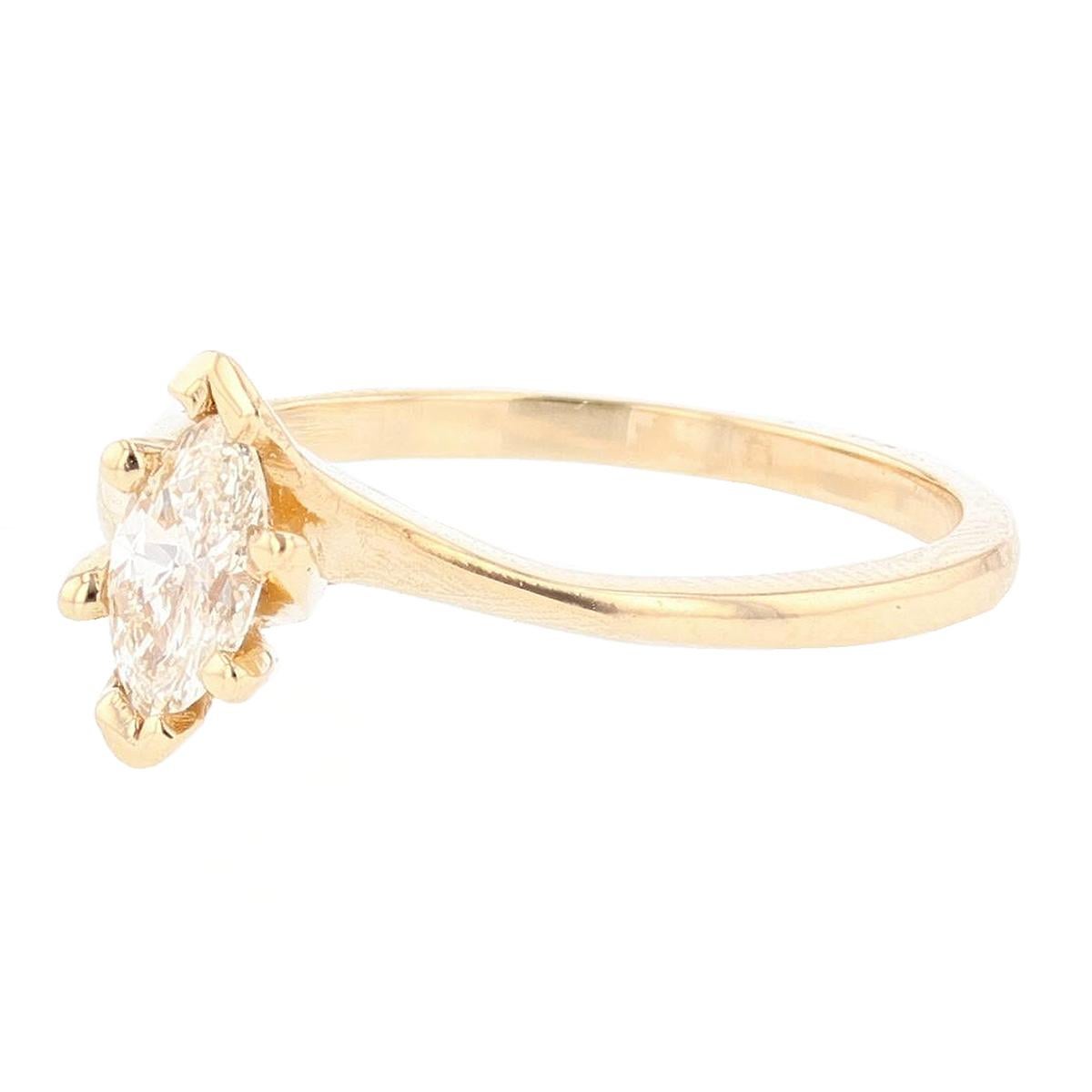 This ring is made with 14 karat yellow and white gold and features a bezel set 0.35ct Marquise cut diamond  with a color grade (H) and clarity grade (SI2). 