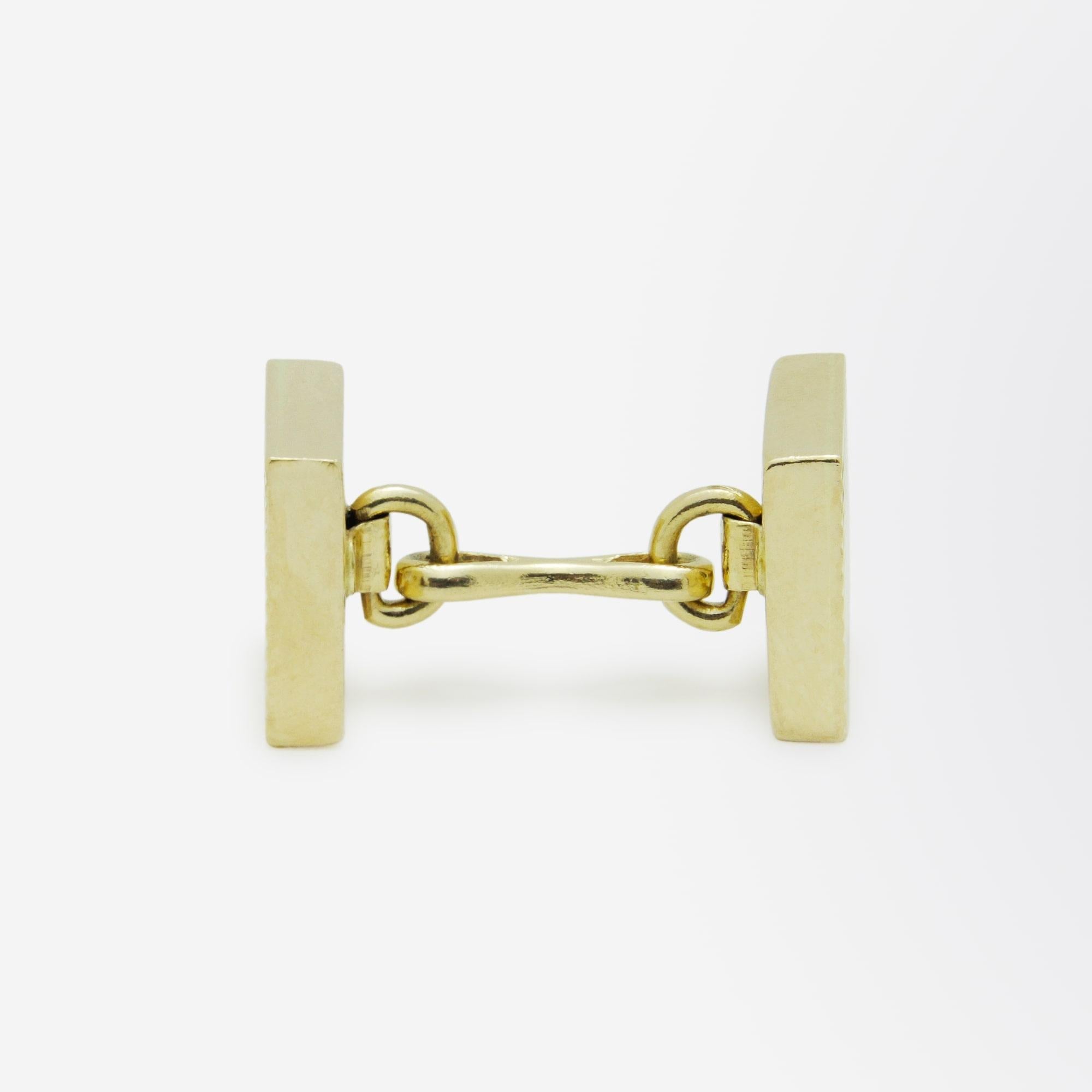 A pair of 14kt yellow gold, square cufflinks by Tiffany and Co. This particular pair likely date to the mid 20th century, circa 1970, and feature a textured ribbed design to the surface of the cufflink panels. These are simple enough to be worn