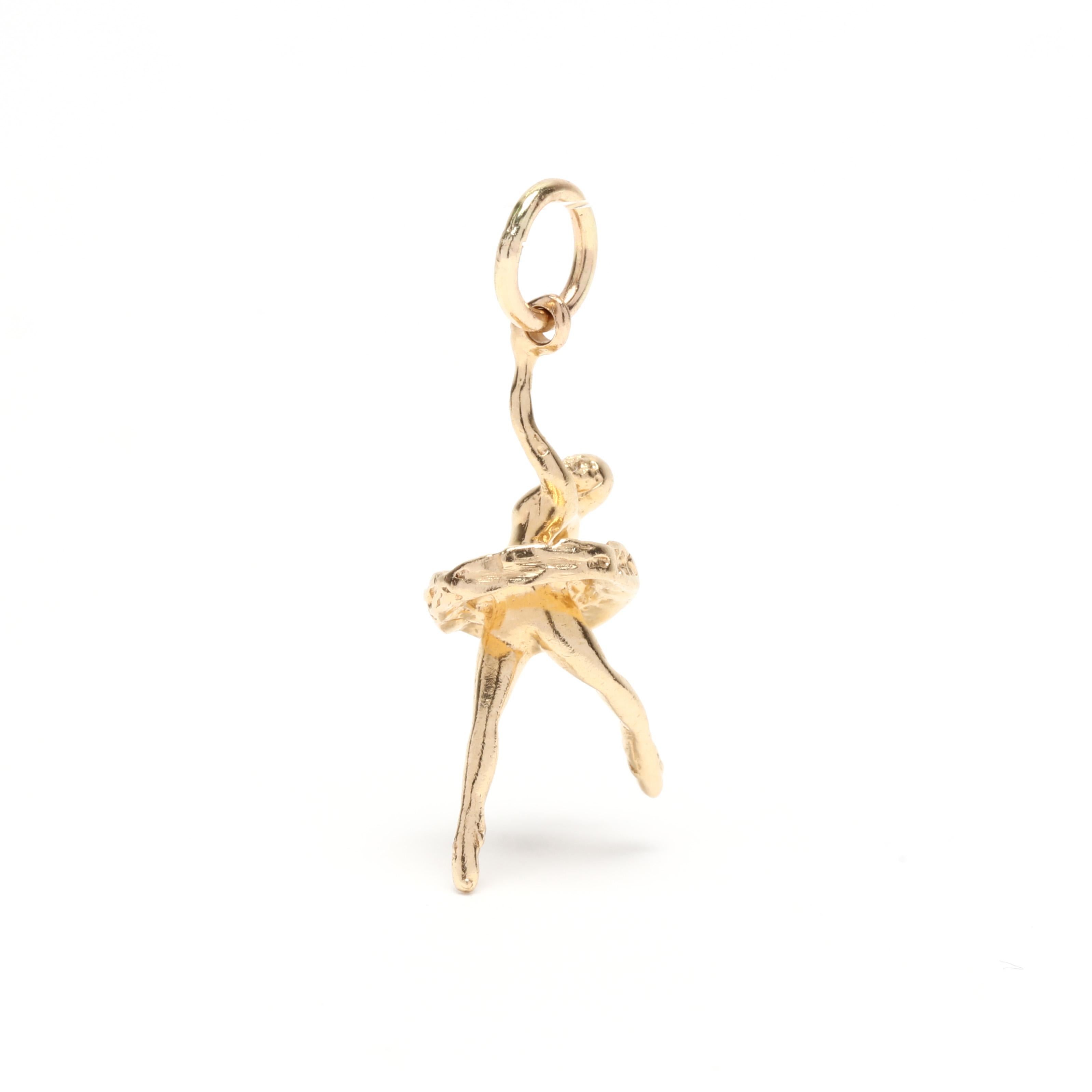 A vintage 14 karat yellow gold mini ballerina charm. This charm features a ballerina dancing in a tutu and with a thin bail.



Length: 7/8 in.



Width: 3/8 in.



Weight: .80 dwts.