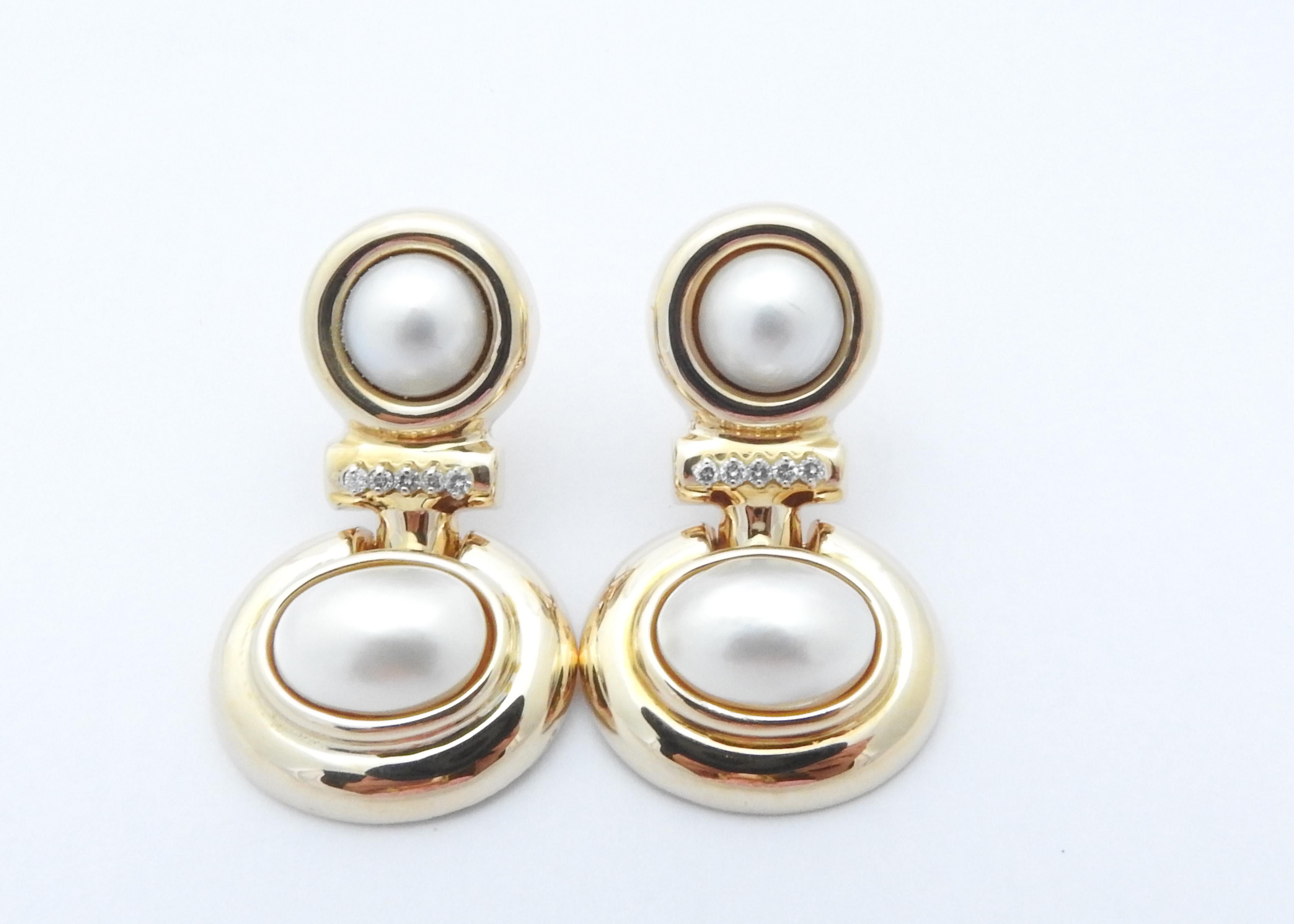 14 Karat Yellow Gold Mobe Pearl and Diamond Earrings-

These lovely earrings each feature two Mobe pearls (upper: 9 mm, lower: 14 mm x 10 mm) and five round brilliant cut diamonds set in beautifully detailed 14K yellow gold.  Hinged
