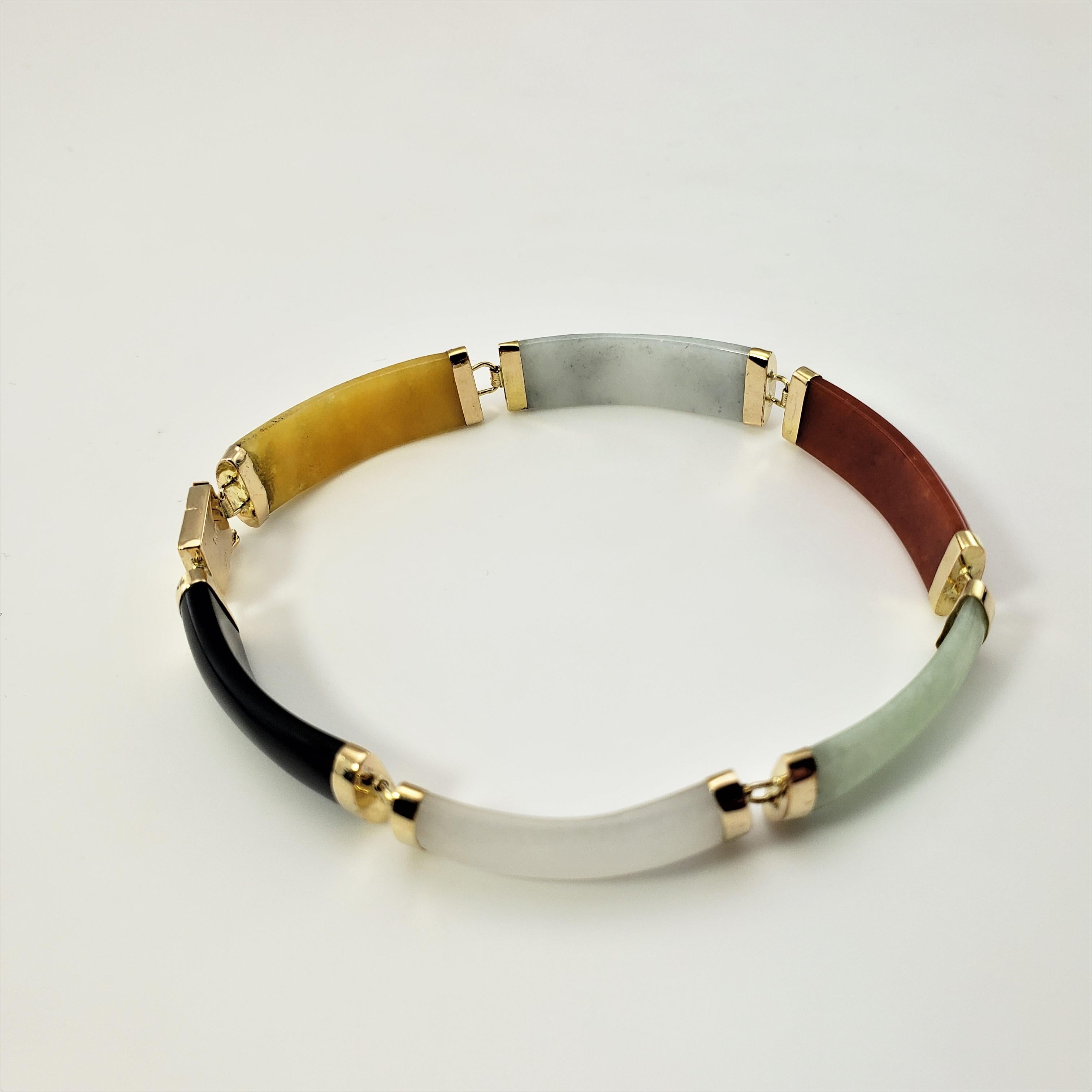 14 Karat Yellow Gold Multi-Colored Jade Bracelet-

This lovely bracelet features six multi-colored jade links set in classic 14K yellow gold.  Width:  8 mm.  

Size:  7 inches 

Weight:  7.2 dwt./  11.3 gr.

Stamped: 14K  585

Very good condition,