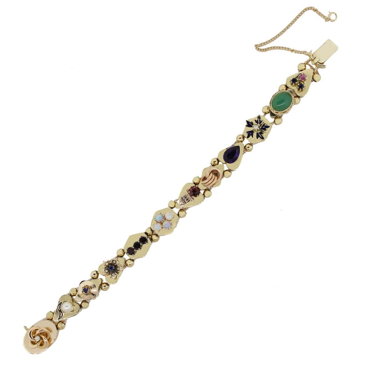 Material: 14k yellow gold
Clasp: Tongue in box with spring ring safety
Gemstone details: Pear shape Amethyst, Opals, Ruby, Rubelite, Pink Sapphire, Blue Sapphire, Enamel, Pearl
Measurement: 7.5
