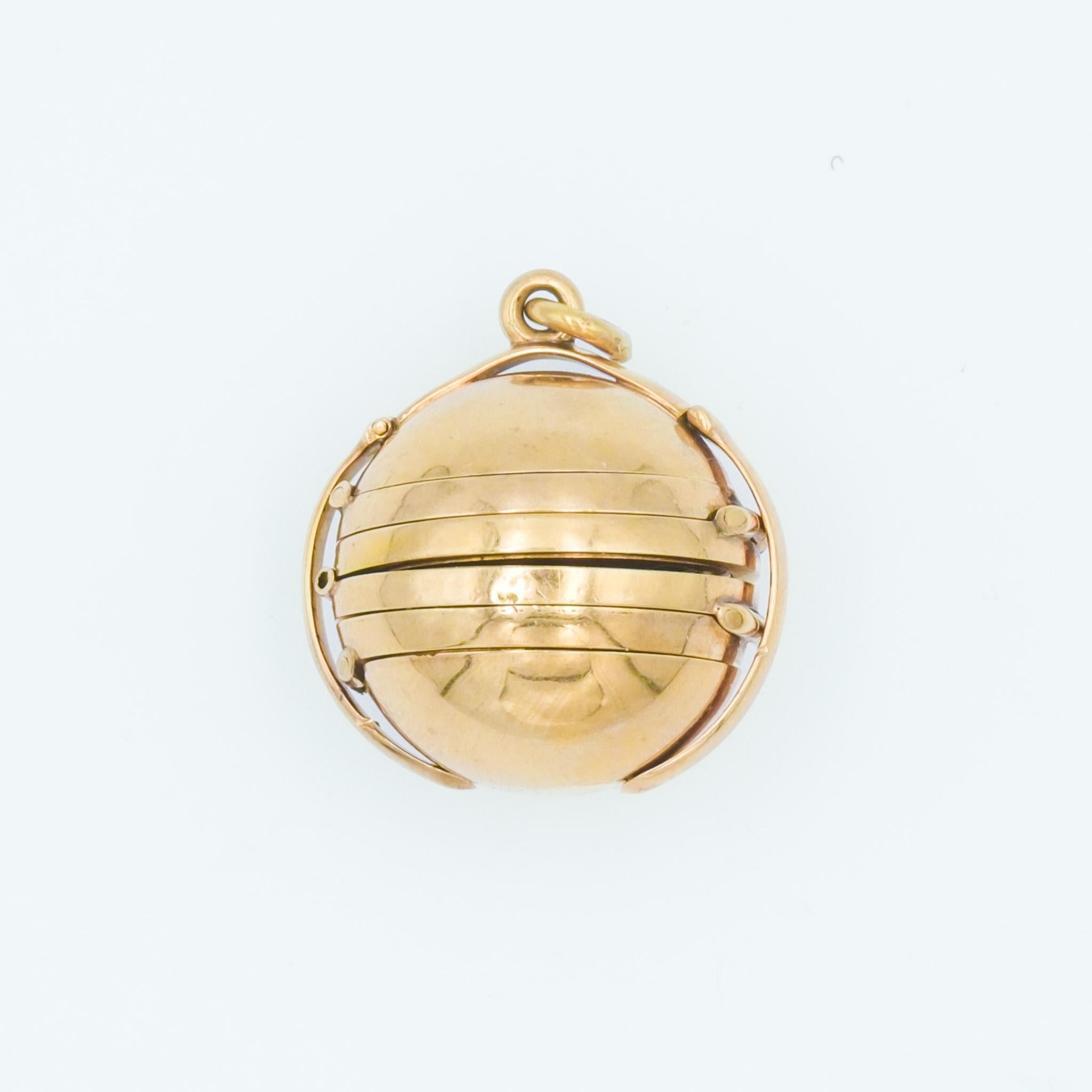 This 14-karat yellow gold locket is a remarkable piece, blending intricate craftsmanship with personal history. 

Designed to resemble a globe, the pendant opens to reveal a multi-photo locket feature, capable of housing six photographs. Two of the