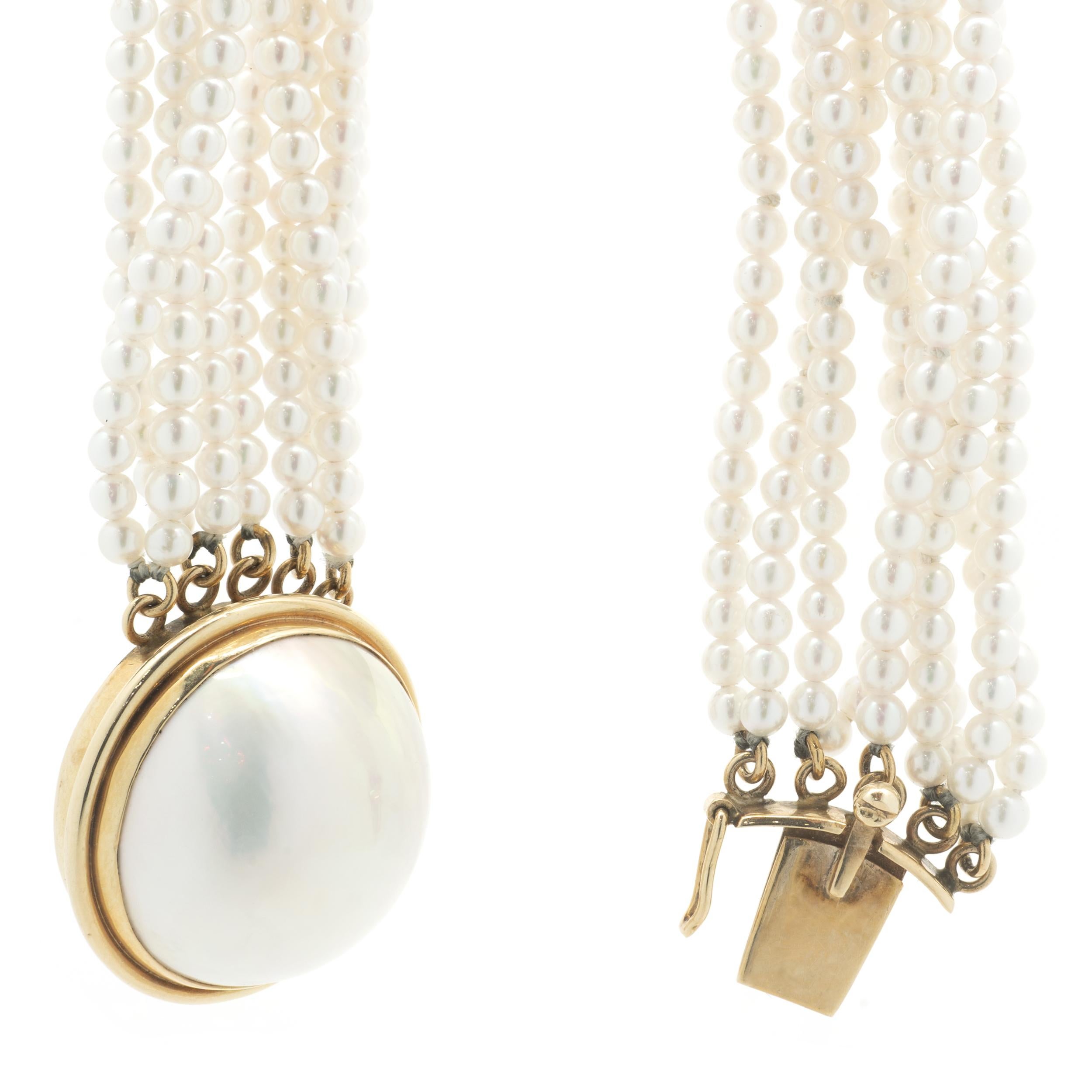 Designer: Custom
Material: 14K yellow gold
Pearl: 20mm Mabe pearl center, 2.5mm seed pearls
Dimensions: necklace measures 16-inches in length
Weight: 48.36 grams