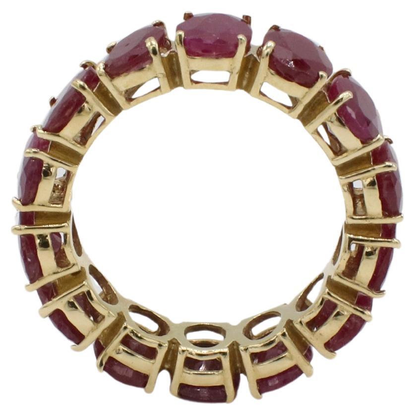 Anello a fascia per l'eternità con rubino ovale naturale in oro giallo 14 carati 
Metallo: oro giallo 14k
Peso: 6.04 grammi
Taglia: 8 (US)
Larghezza: 7 mm
Rubini: Circa 8,50 rubini ovali naturali CTW (circa .60 punti ciascuno)
SDD F35001562