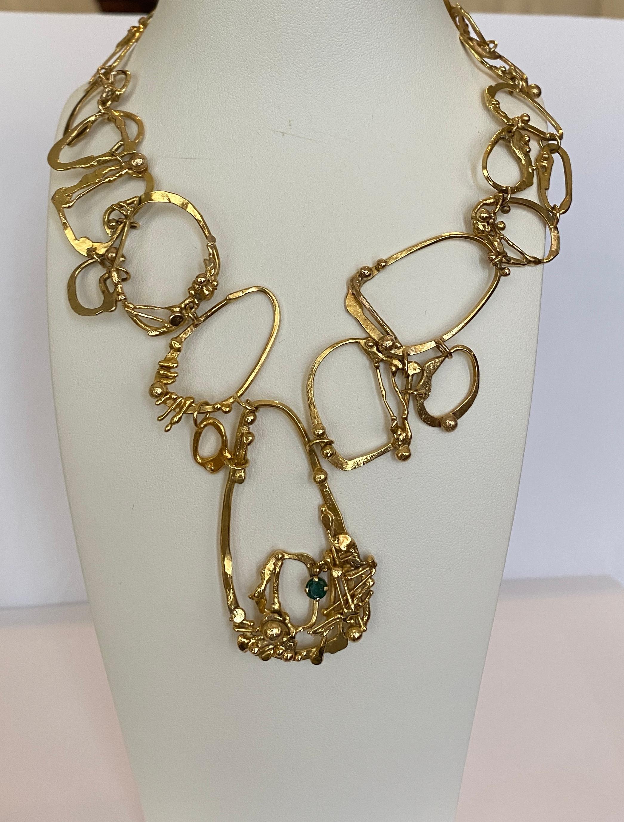 Offered in good condition, 14 KT yellow gold handmade design necklace with 1 piece of round cut emerald approx. 0.40 ct. Origin: Israel

Necklace has been marked 14 KT
Natural emerald: 0.40 crt (treatment unknown)
Weight: 61.2 grams
Length of the