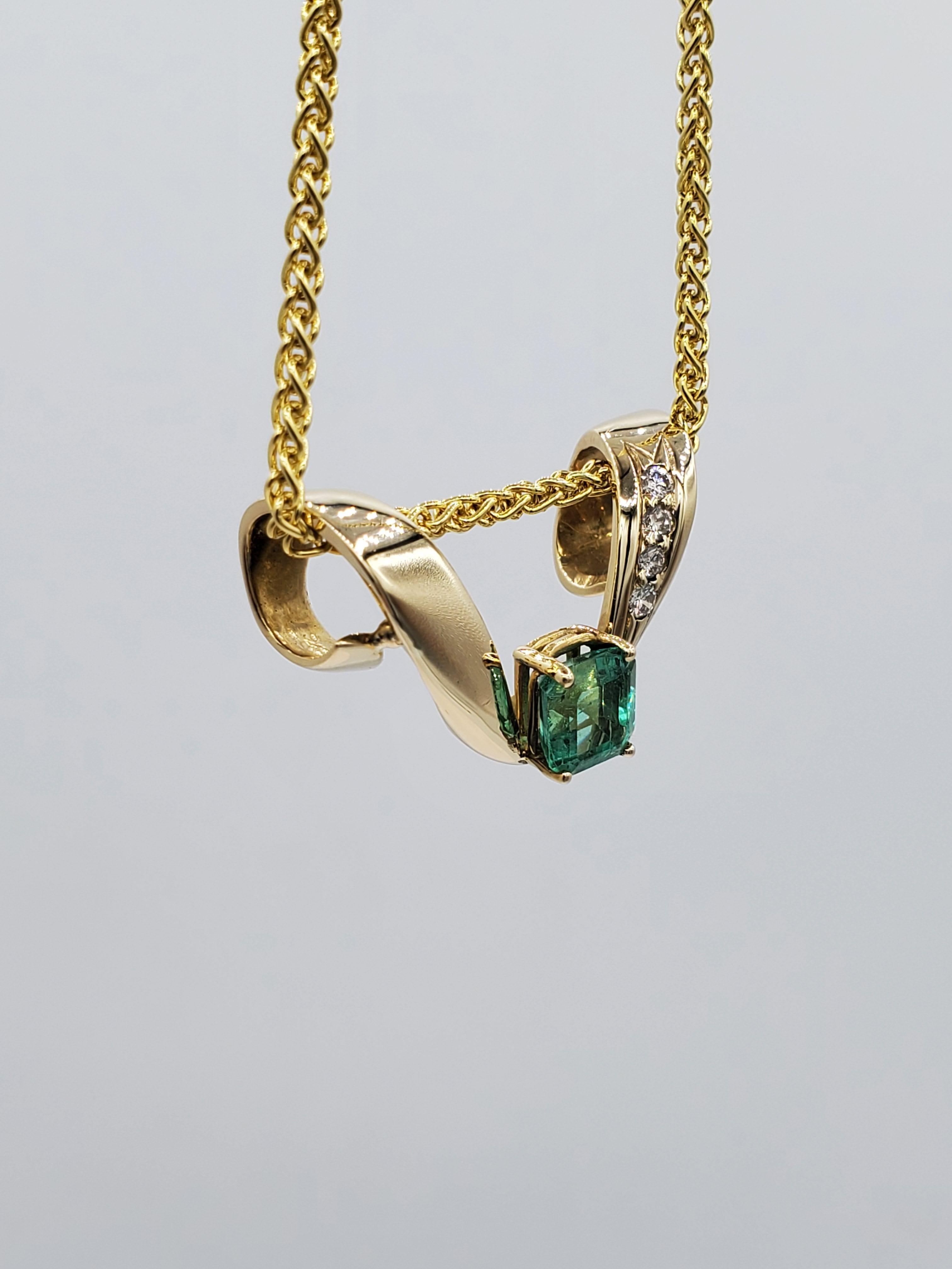 14kt Yellow Gold Omega Necklace Enhancer, Vibrant Natural Emerald 6.9mm x 6.3mm Size, 4 Quality Round Diamond of Approx. .08cttw.

This preowned Omega Necklace enhancer is in good condition. The emerald has a bright green color, with hairline