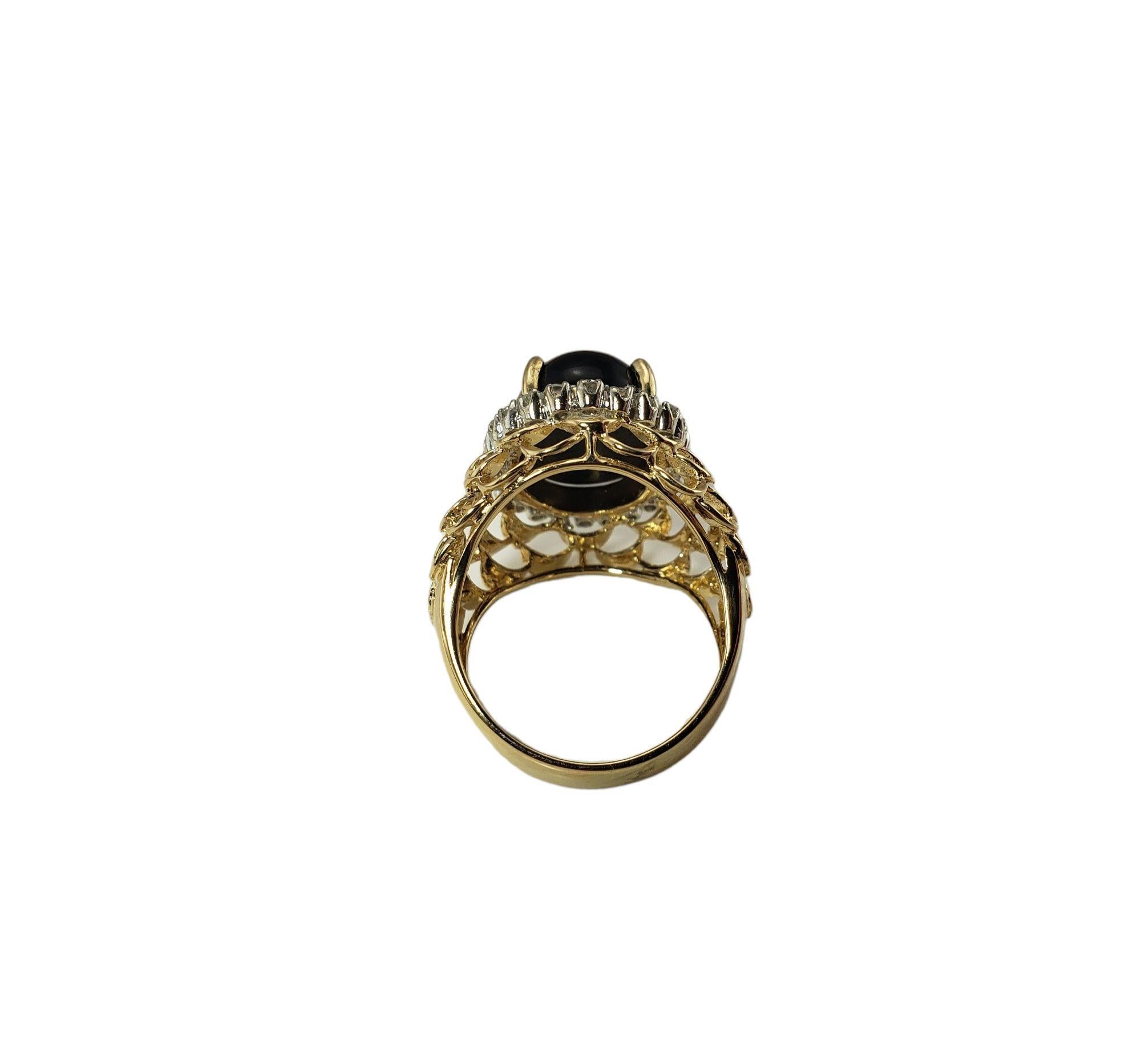Vintage 14 Karat Yellow Gold Onyx and Diamond Ring Size 7.5-

This lovely ring features one cabochon onyx stone (15 mm x 11 mm) and 24 round brilliant cut diamonds set in beautifully detailed 14K yellow gold. Width: 20 mm. Height: 14 mm. Shank: 5