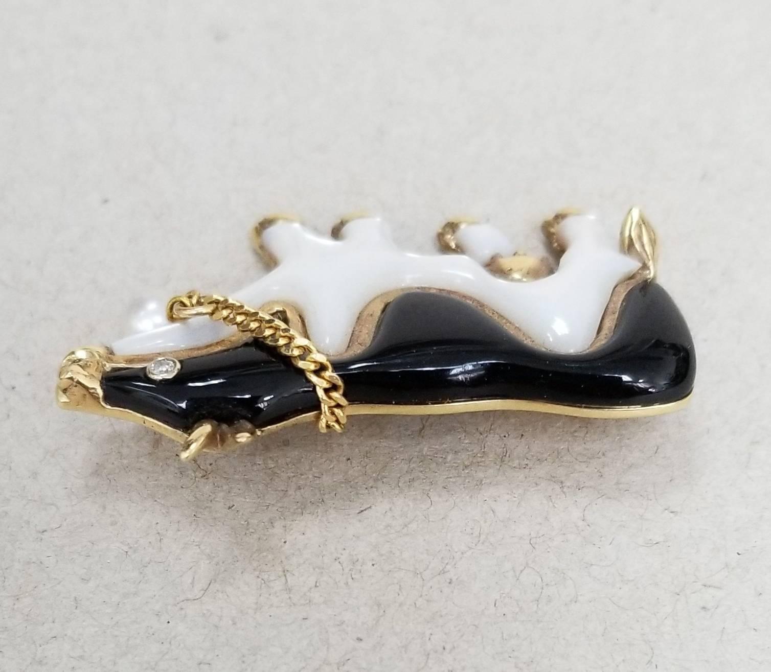 Beautiful designed by Gresha 14k yellow gold onyx and mother of pearl cow brooch with diamond eye and pearl bell on chain.  The piece was hand carved and fitted to the gold layout.