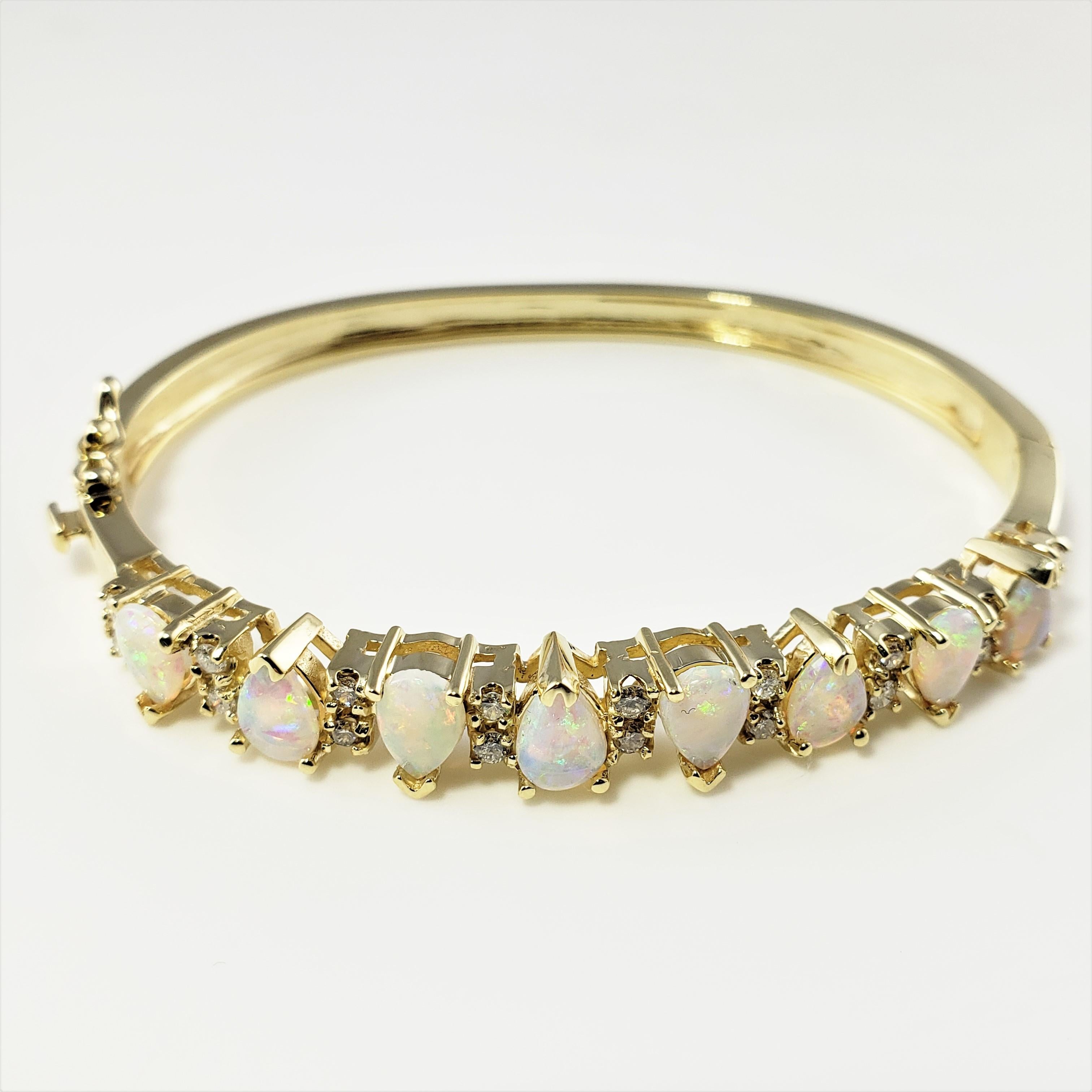 14 Karat Yellow Gold Opal and Diamond Bangle Bracelet-

This stunning hinged bangle bracelet features eight pear shaped opals (8 mm x 5 mm each) and 21 round brilliant cut diamonds set in classic 14K yellow gold.  Width:  8 mm.

Approximate total