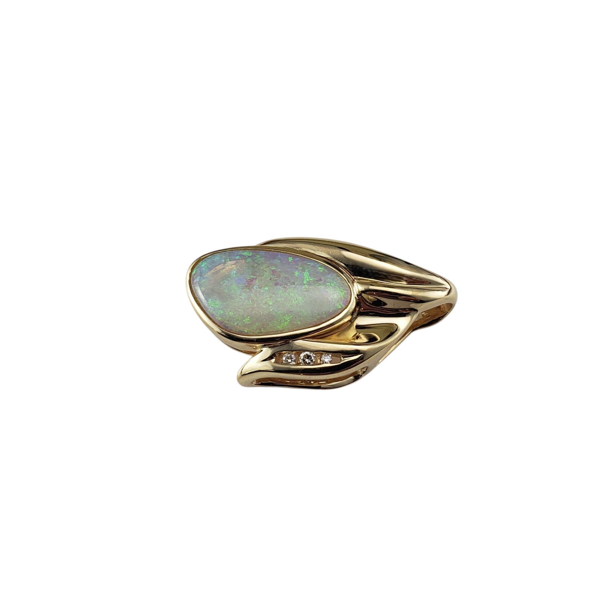 14 Karat Yellow Gold Opal and Diamond Pendant-

This unique slide pendant features a colorful freeform opal bezel-set in rich 14K yellow gold. A vertical row of three round brilliant cut diamonds add sparkle to this lovely piece.

Pendant has a