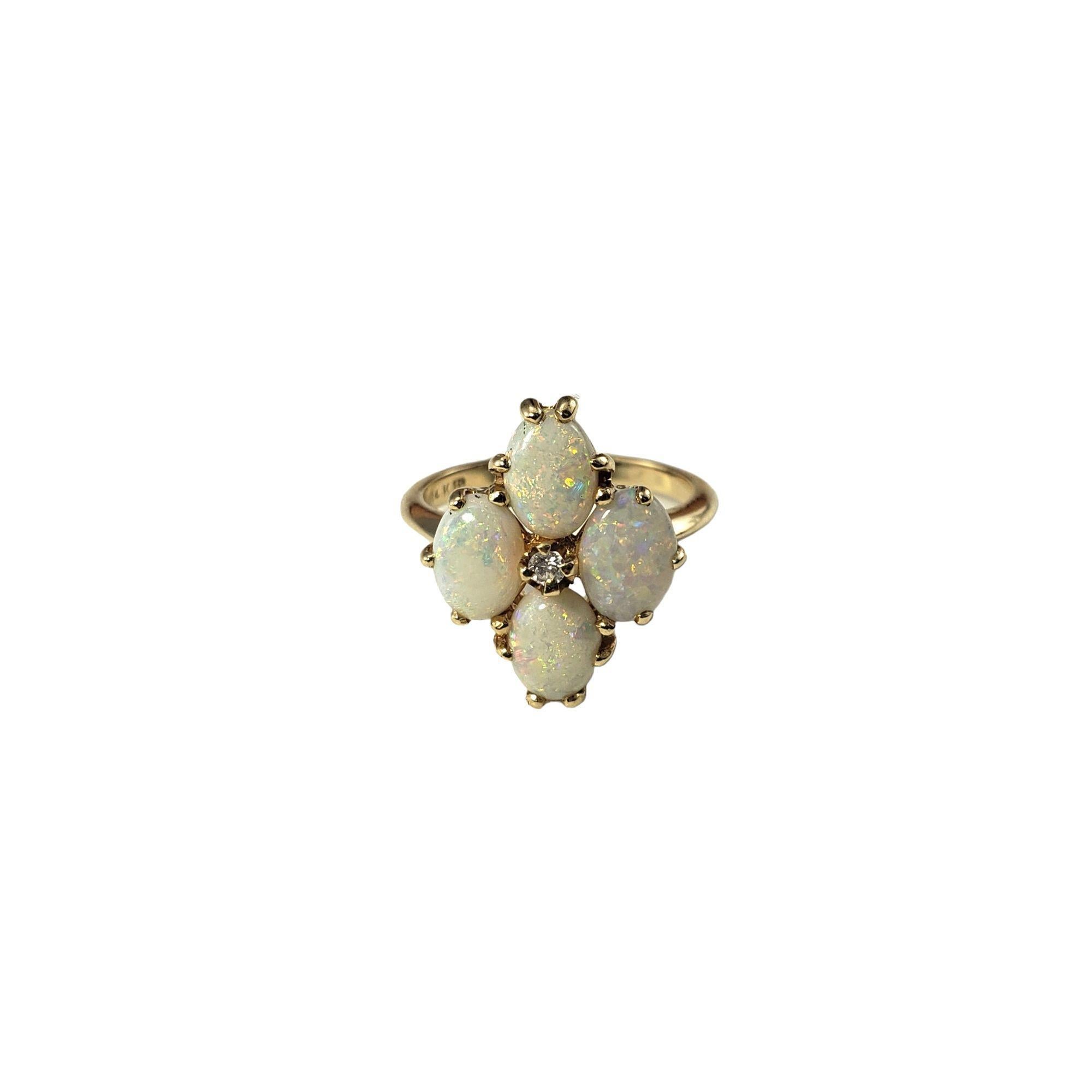 14 Karat Yellow Gold Opal and Diamond Ring Size 5.75-

This stunning ring features four oval opal stones (7 mm x 5 mm each) and one round brilliant cut diamond set in classic 14K yellow gold. Width: 17 mm. Shank: 2 mm.

Approximate diamond