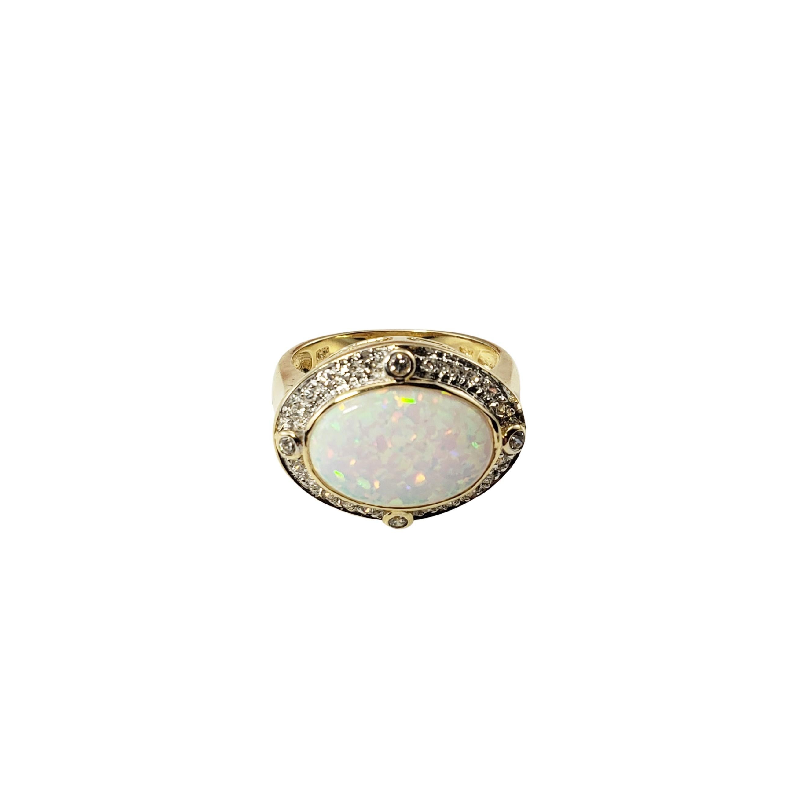 Vintage 14 Karat Yellow Gold Opal and Diamond Ring Size 7-

This lovely ring features one oval opal (15 mm x 10 mm), four round brilliant cut diamonds (.08 TCW) and 20 round single cut diamonds (.15 TCW) set in classic 14K yellow gold.  Top of ring