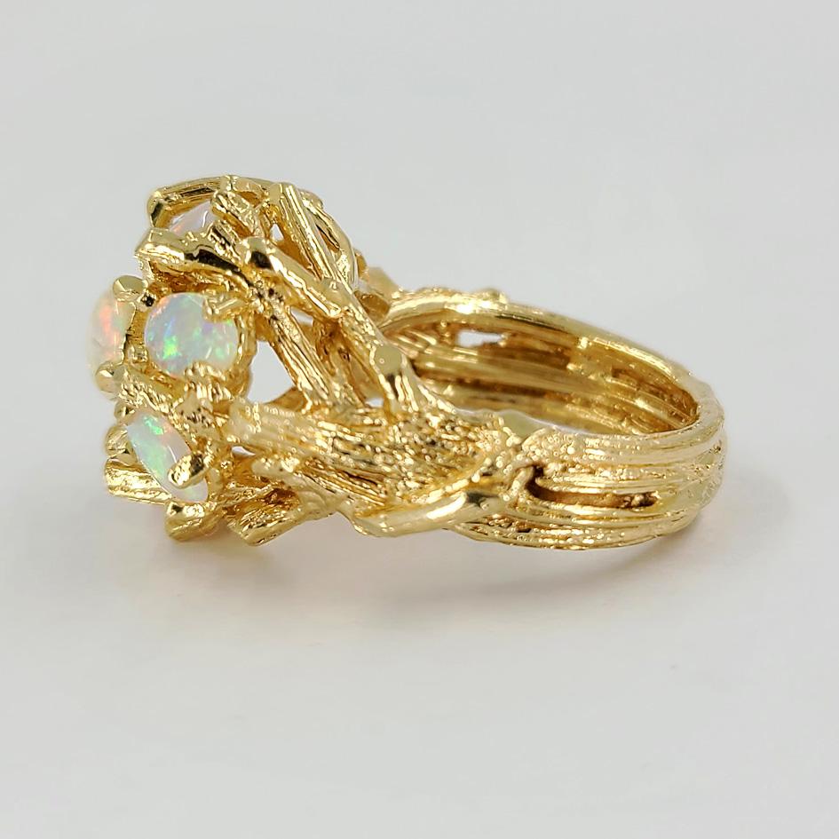 14 Karat Yellow Gold Ring Featuring A Cluster of 7 Oval & Round Opals Totaling Approximately 2.00 Carats In A Textured Branch Design. Current Finger Size 7; Purchase Includes One Sizing Service Up Or Down 2 Sizes. Finished Weight Is 11.0 Grams.