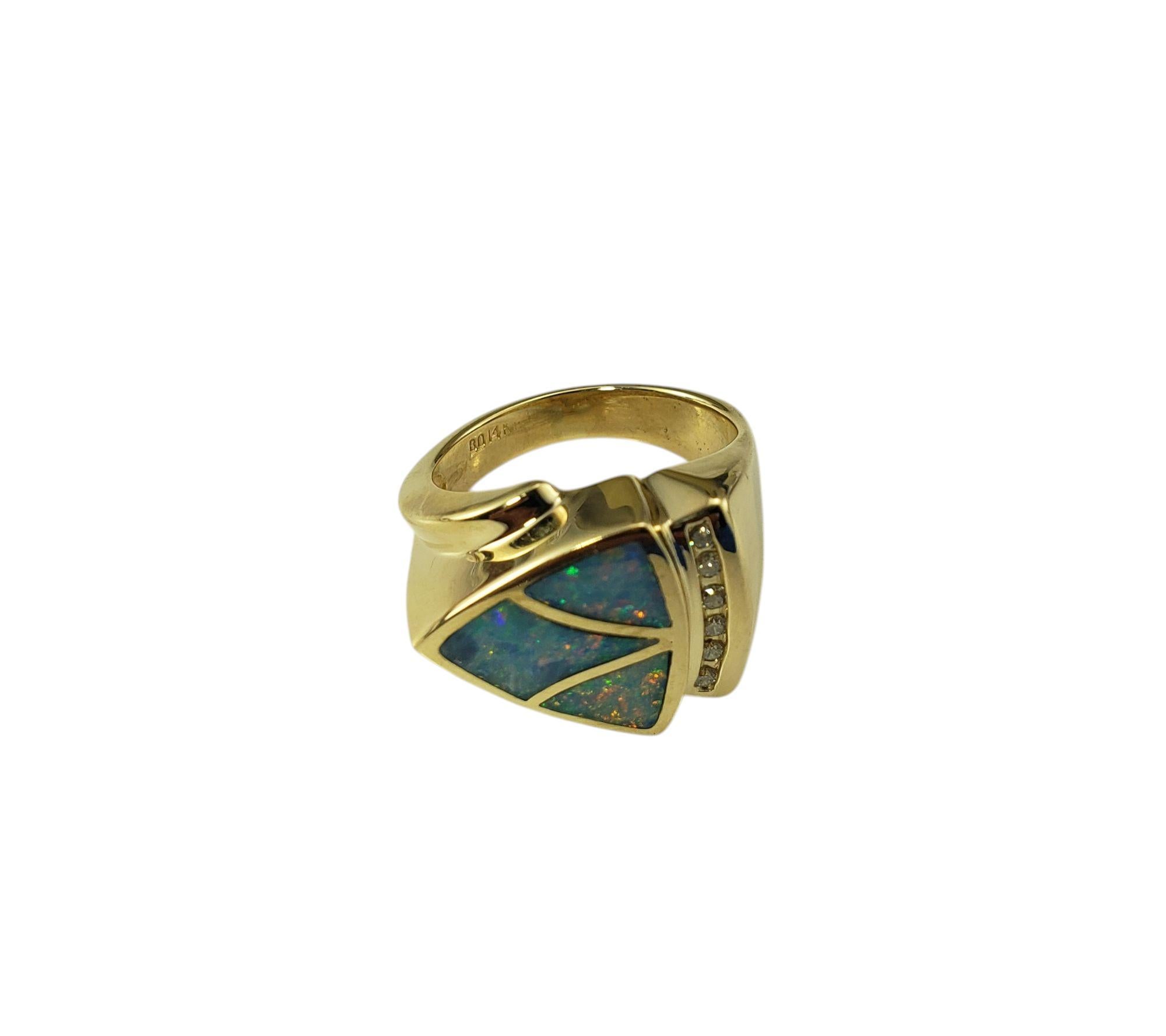 14K Yellow Gold Opal Inlay and Diamond Ring Size 6 JAGi Certified-

This elegant Modernist style ring features three inlay opal slices and six round brilliant cut diamonds set in beautifully detailed 14K yellow gold.

Width: 15 mm.
Shank: 3.5