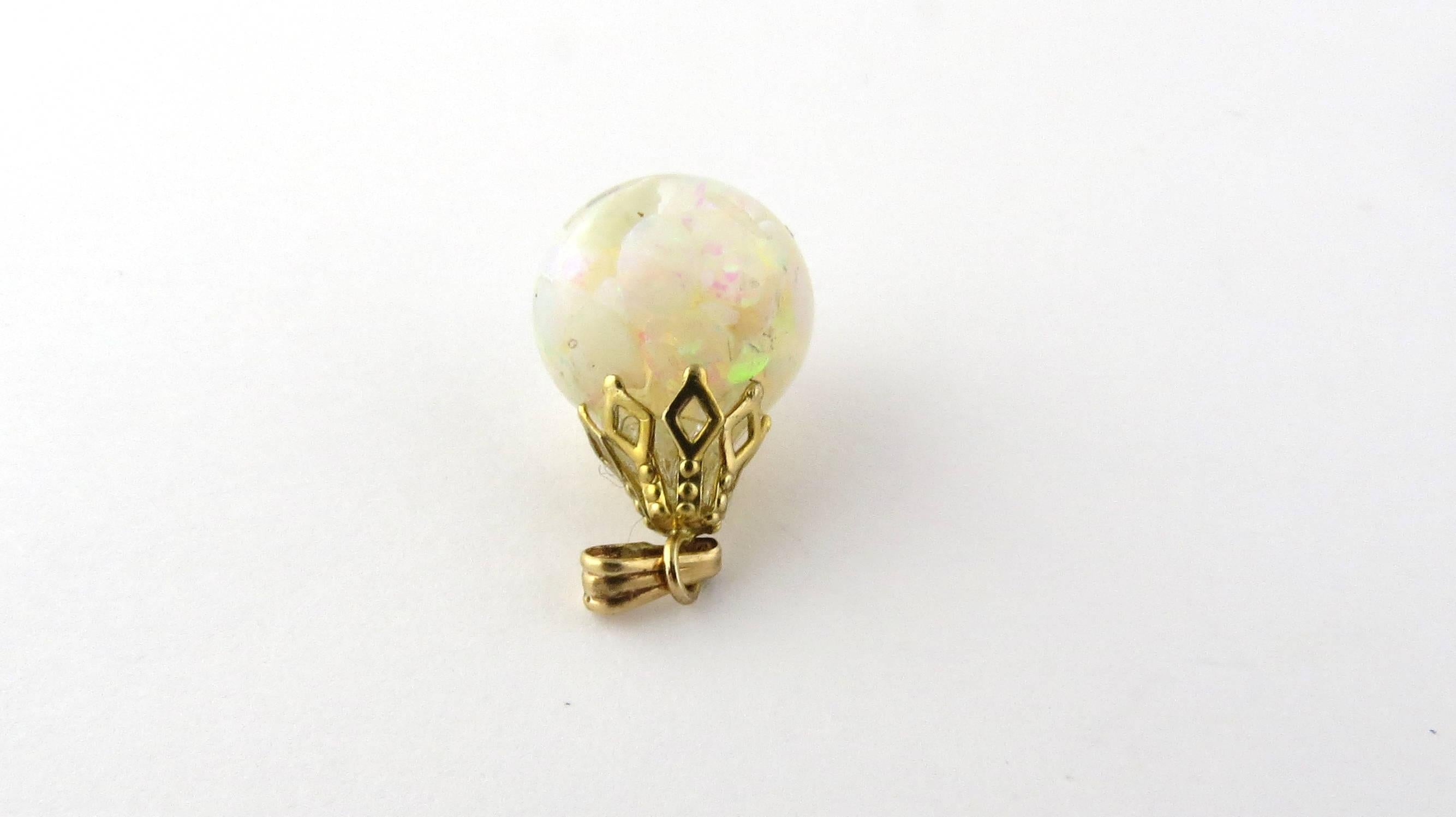 Vintage 14 Karat Yellow Gold Opal Pendant-

This unique pendant features a glass drop filled with genuine opal chips and held by a beautifully embossed yellow gold setting.

Size: 19 mm x 12 mm (actual pendant)

Weight: 1.2 dwt. / 2.0 gr.

Hallmark: