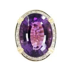 14 Karat Yellow Gold Oval Amethyst 
Diamond Halo Ring