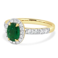 14 Karat Yellow Gold Oval Cut Emerald and Round Diamond Halo Ring