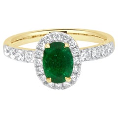 14 Karat Yellow Gold Oval Cut Emerald and Round Diamond Halo Ring
