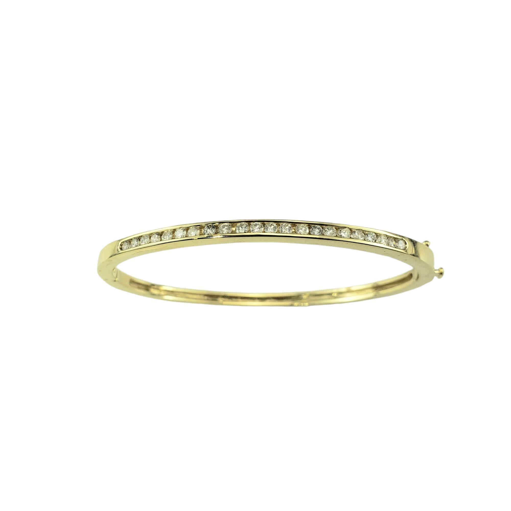 14 Karat Yellow Gold and Diamond Bangle Bracelet-

This sparkling hinged bangle bracelet features 22 round brilliant cut diamonds set in classic 14K yellow gold.

Width: 4 mm.

Approximate total diamond weight: .70 ct. - .88 ct.

Diamond color: